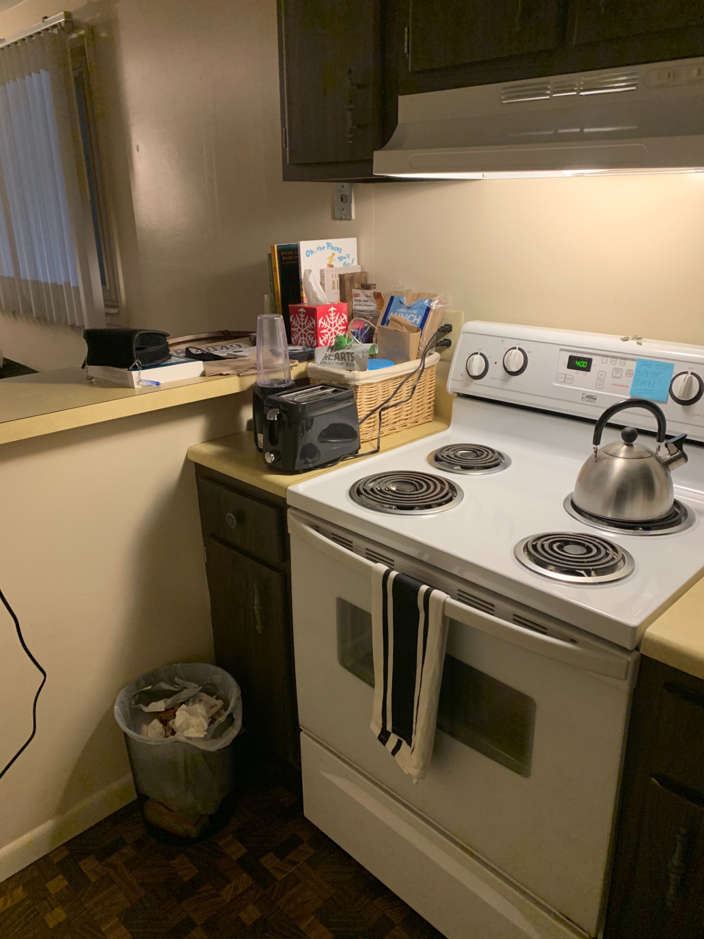 2030 Summit St Unit 1 kitchen with electric range and dark wood cabinets