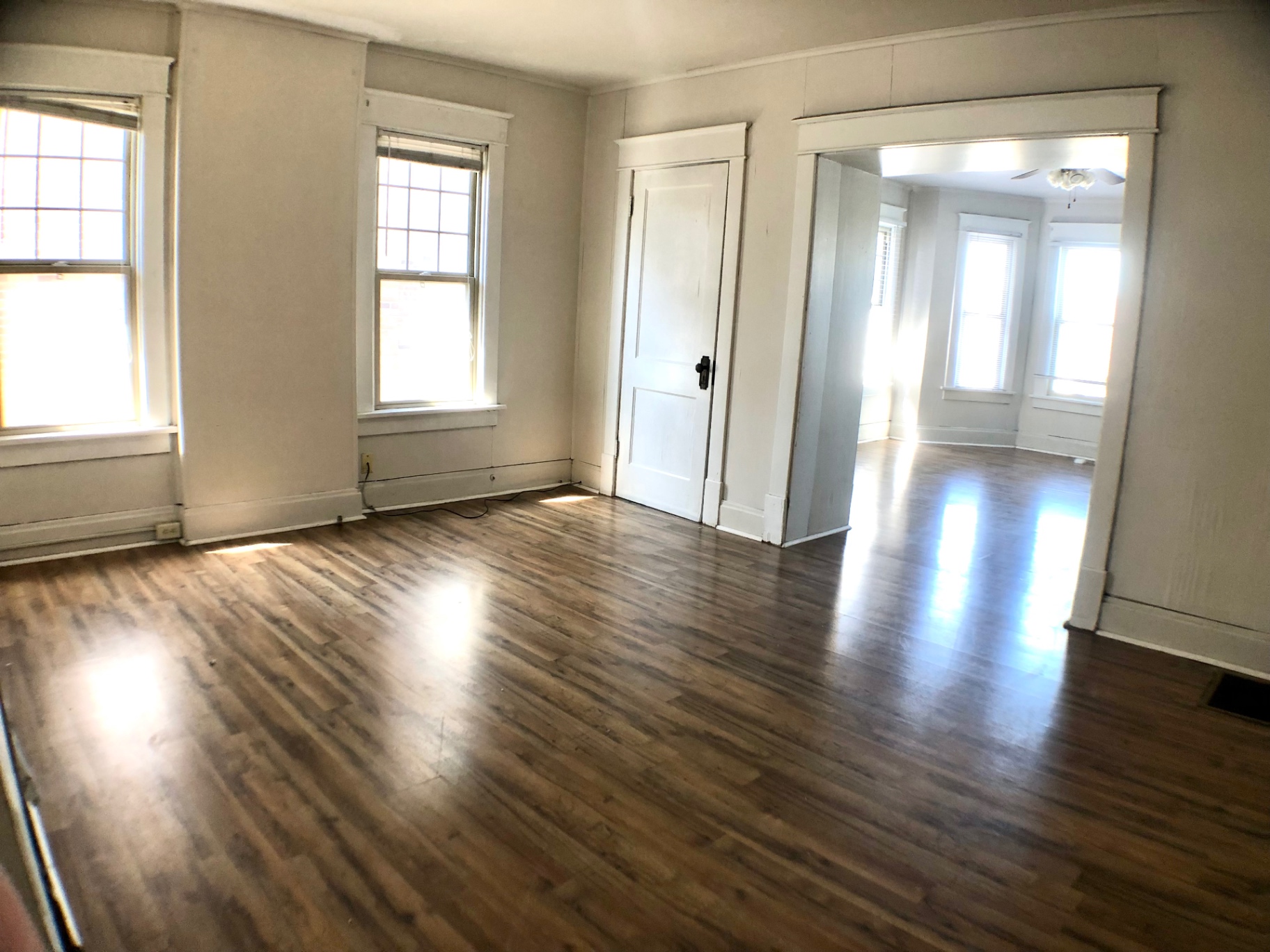 1814 Summit St. front room with hardwood floors opening into the bay-window living area