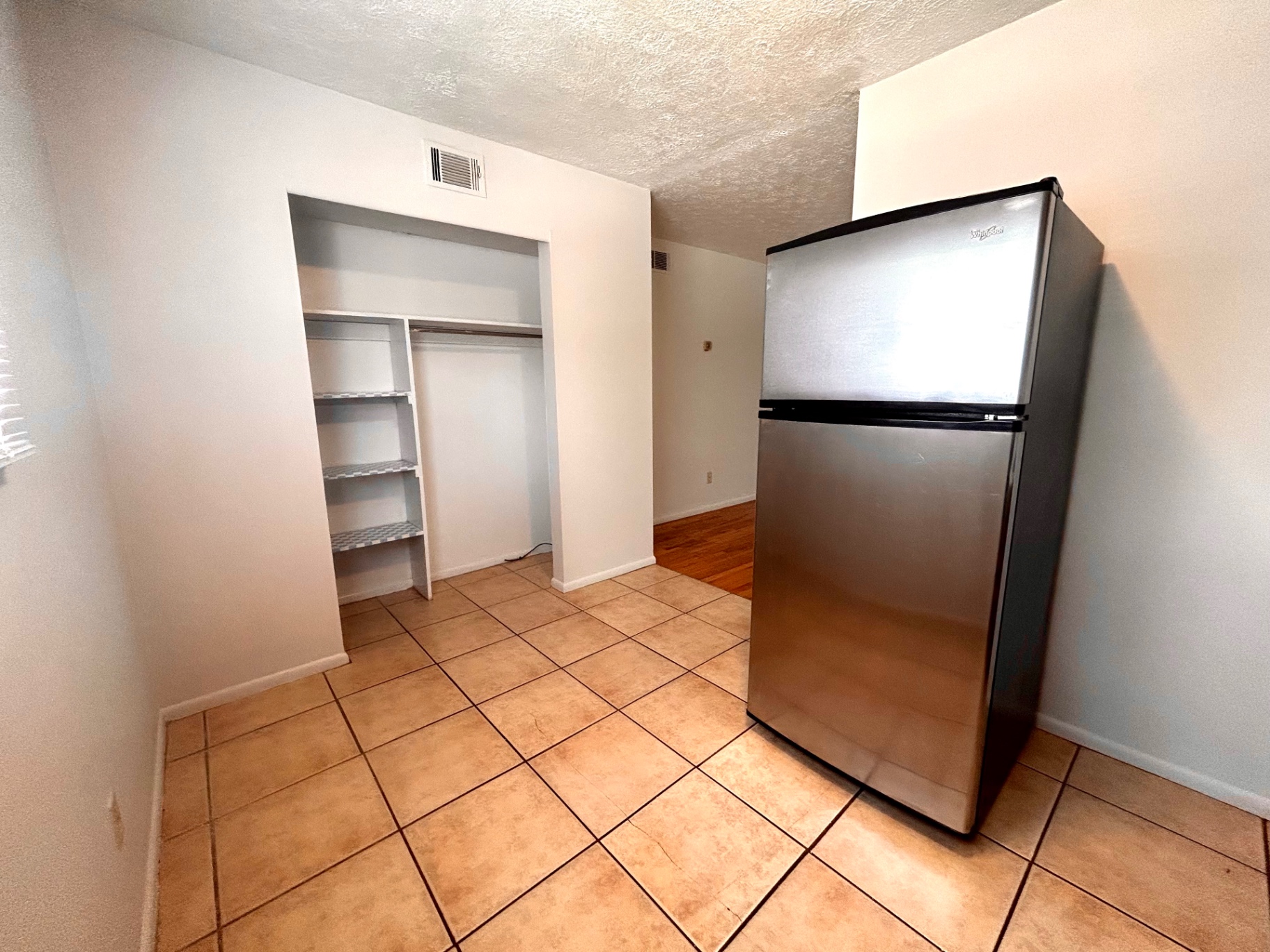 2150 N 4th St. Unit C dining nook with built-in pantry shelving and stainless fridge