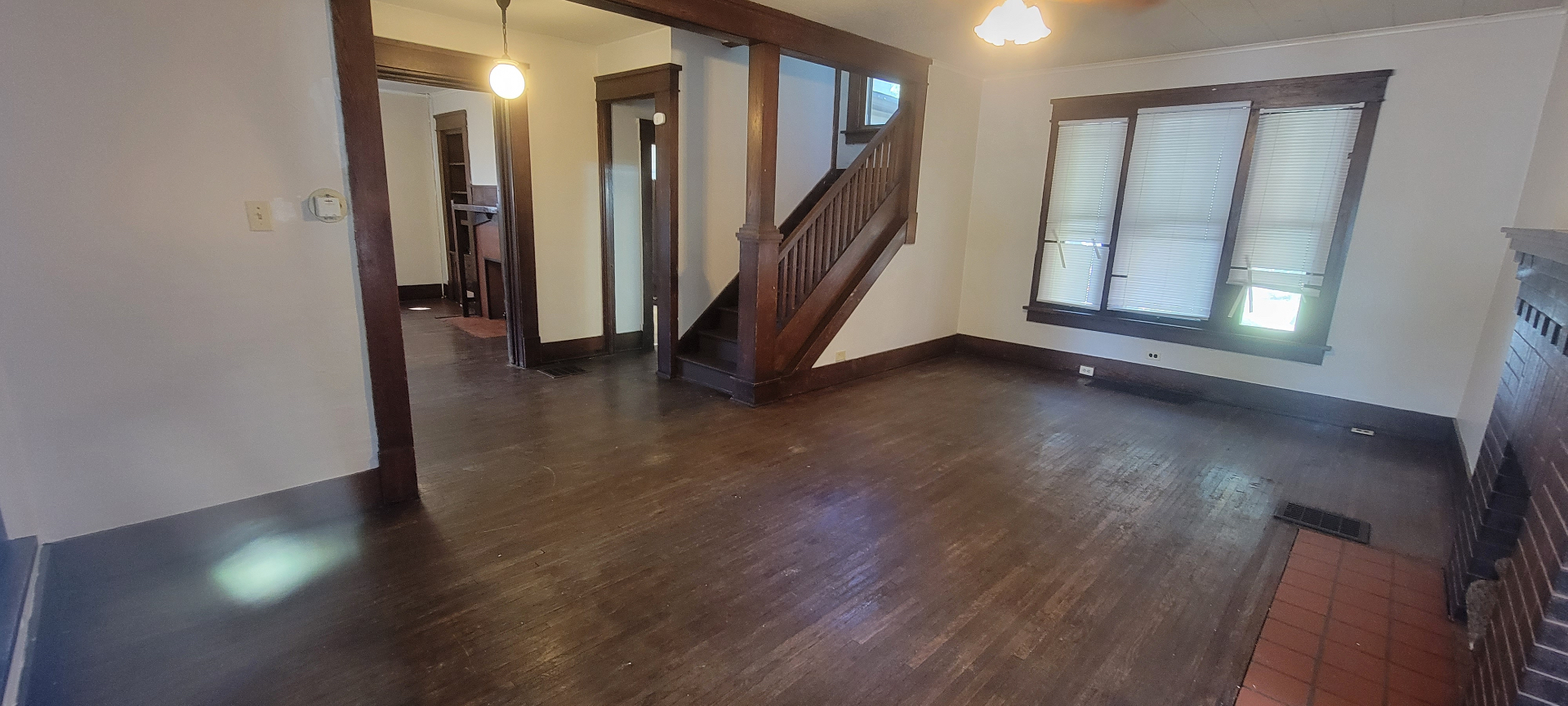 2015 Summit St. open living and dining area with original wood staircase and hardwood floors
