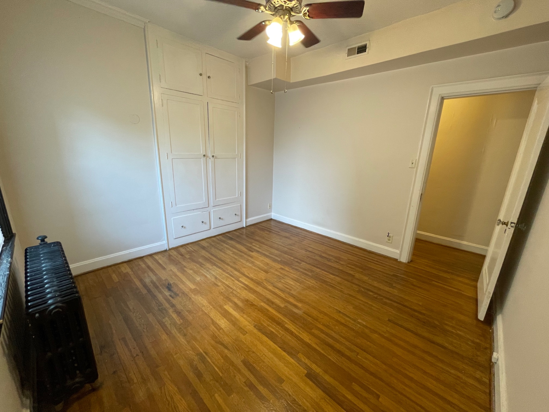 Unit E third bedroom area with hardwood floors