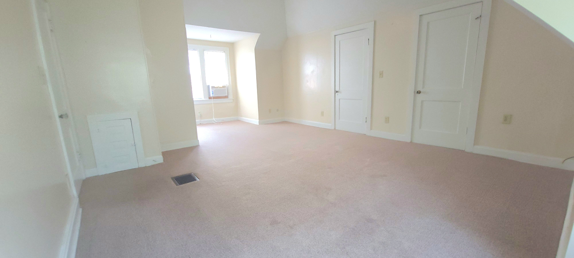 2054 Iuka Ave. C broad bedroom layout with soft natural light and expansive floor space