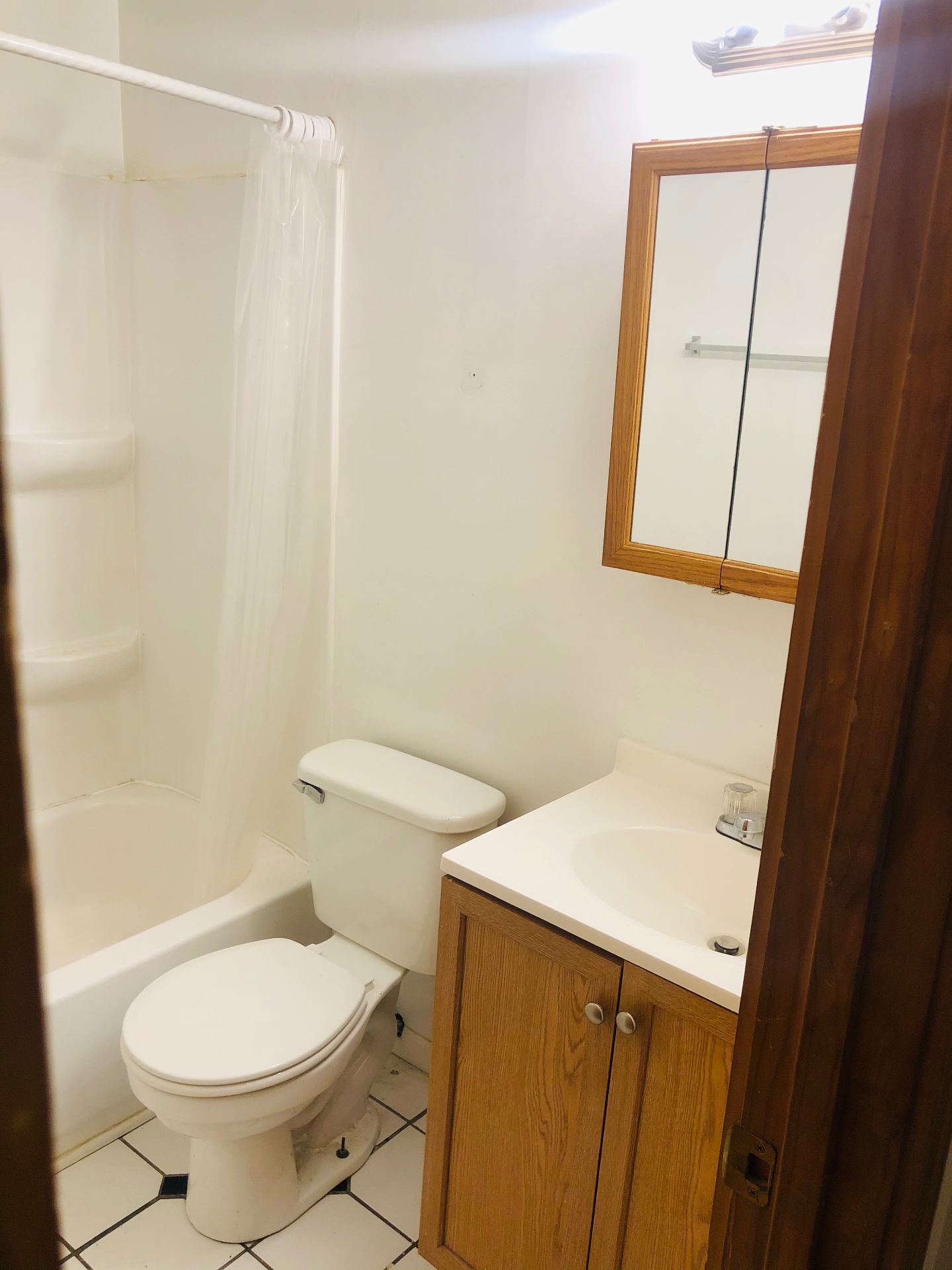 2150 N 4th St. Unit A bathroom with tub/shower, oak vanity, and mirrored medicine cabinet