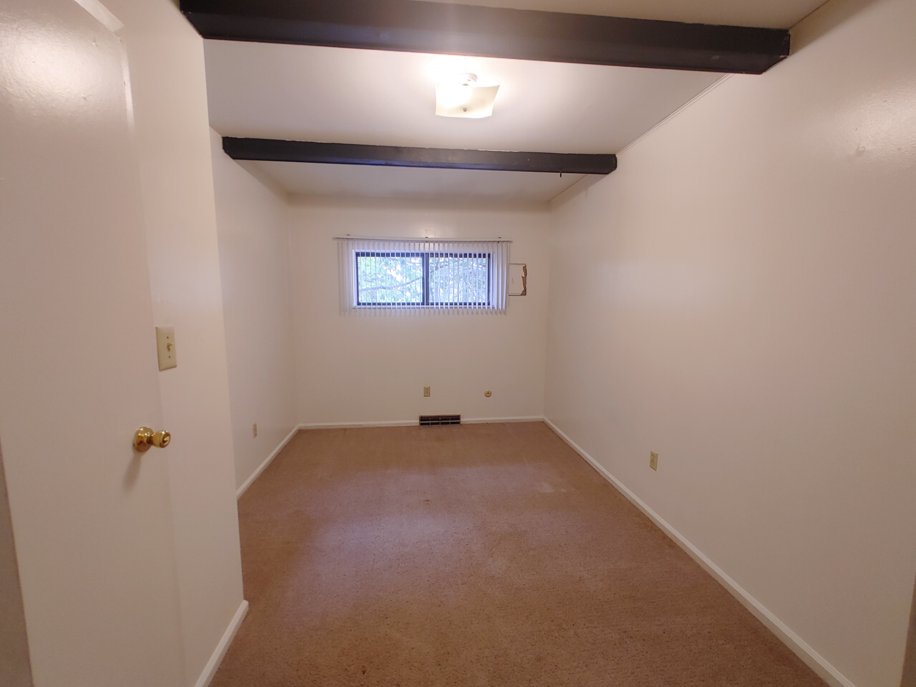 2018 Iuka Ave. second bedroom with exposed ceiling beams and carpeted floor