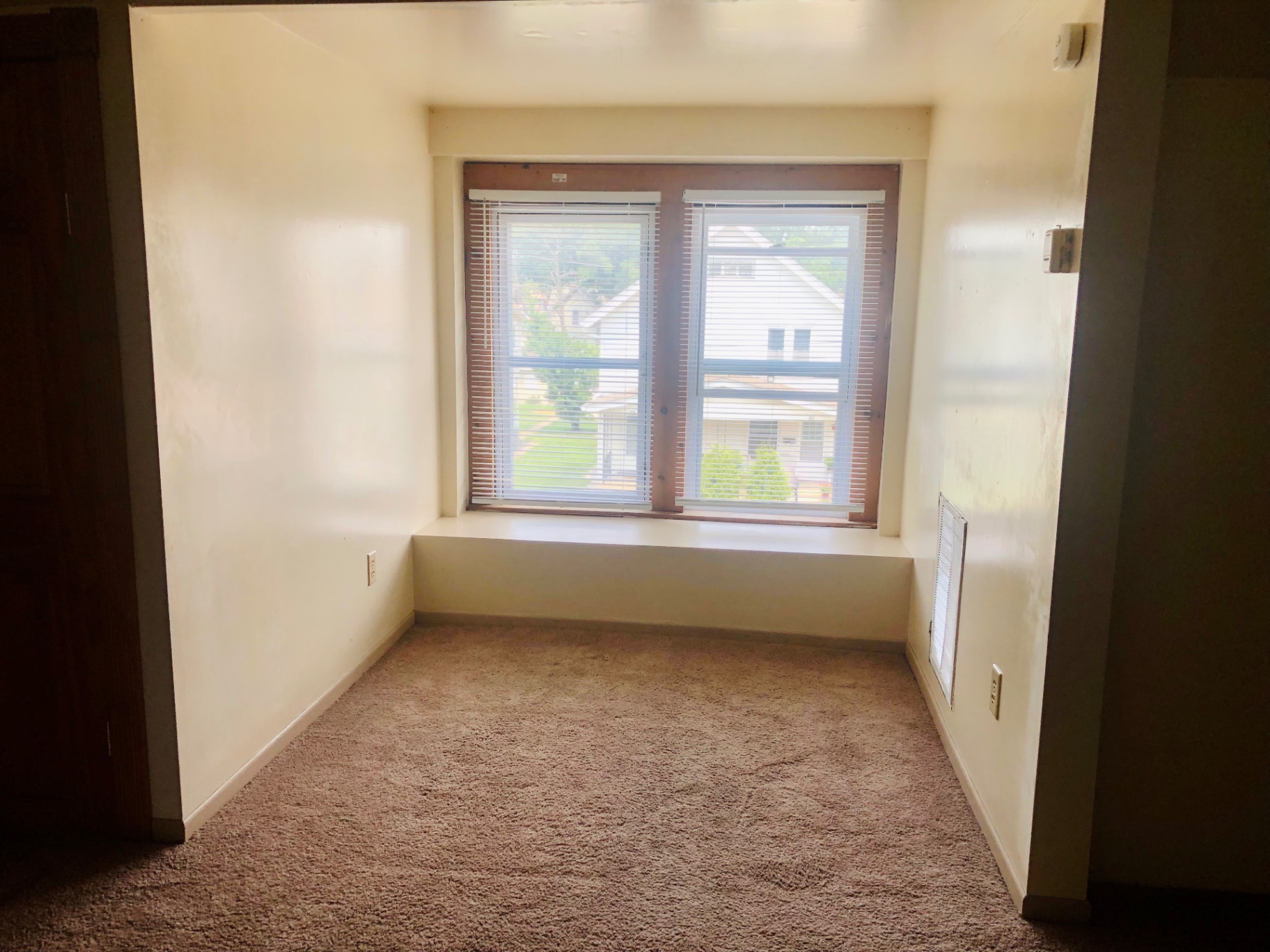 77 E Patterson Ave. carpeted bedroom with large window looking out over the neighborhood