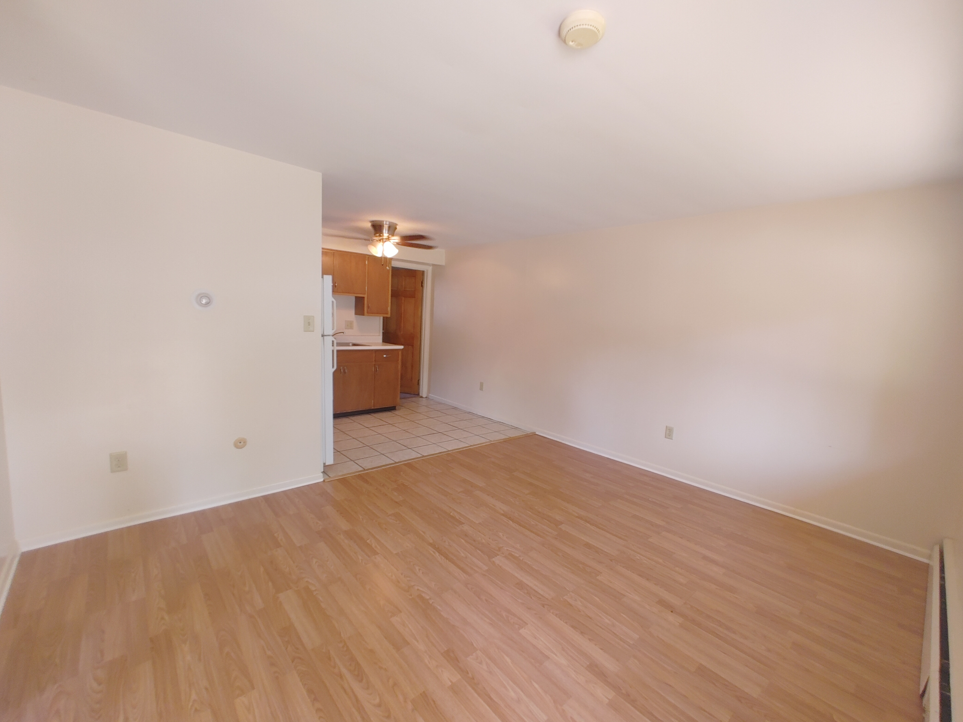 1827 N 4th St. Unit 3 wide living room view with ceiling fan and kitchen entry
