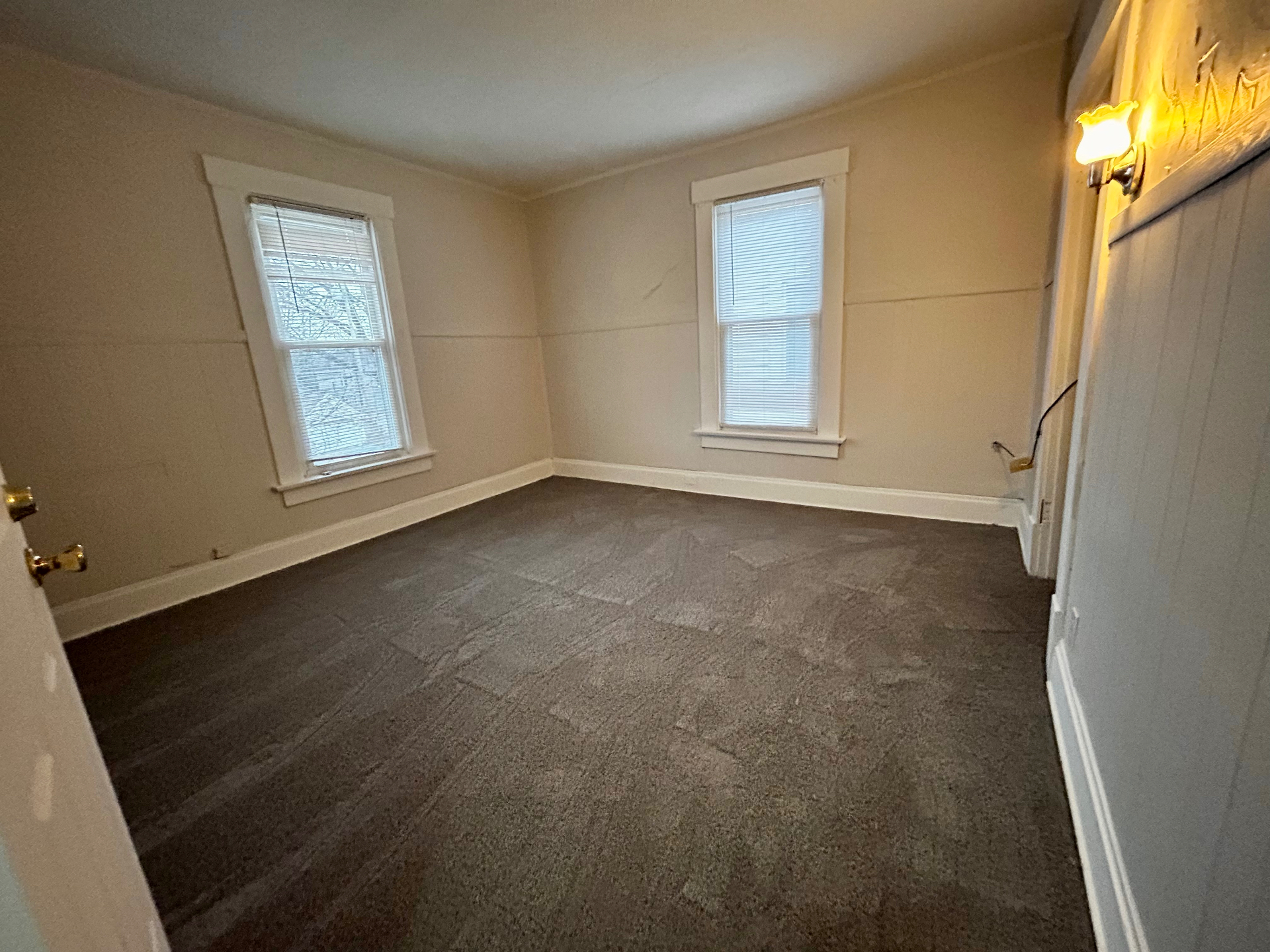 68 E Patterson Ave. carpeted bedroom with two bright windows and wall sconce