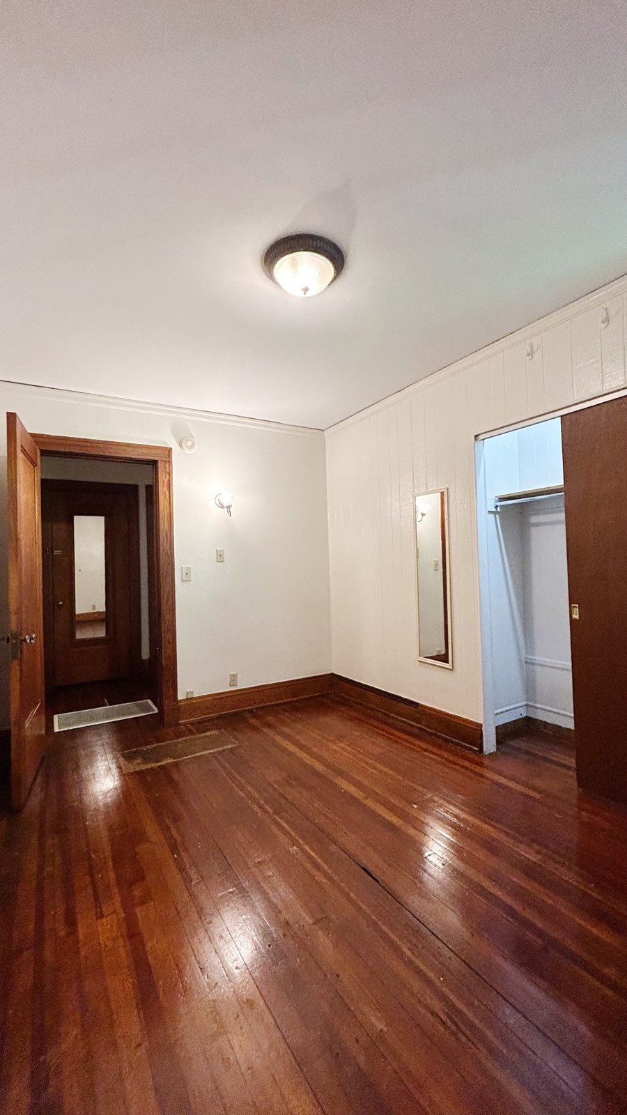 2026 Iuka Ave C bedroom with hardwood floors, wall sconce, and large closet