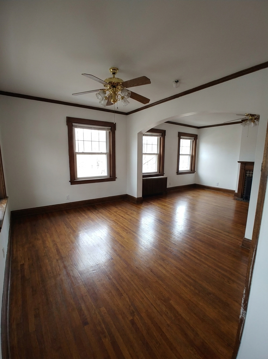Unit C dining and living area with dark wood trim and fireplace