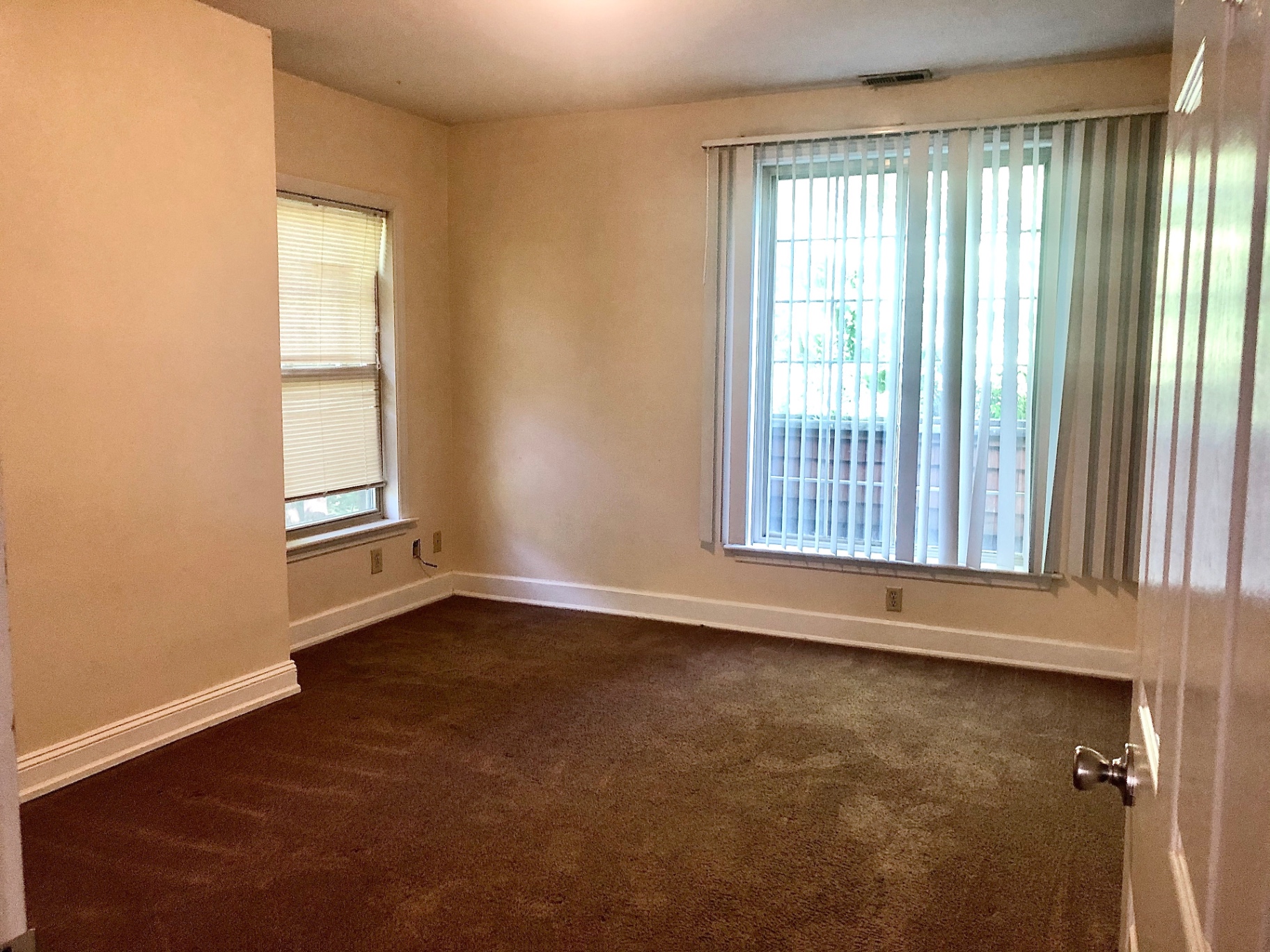2034 Iuka Ave A carpeted bedroom with large windows
