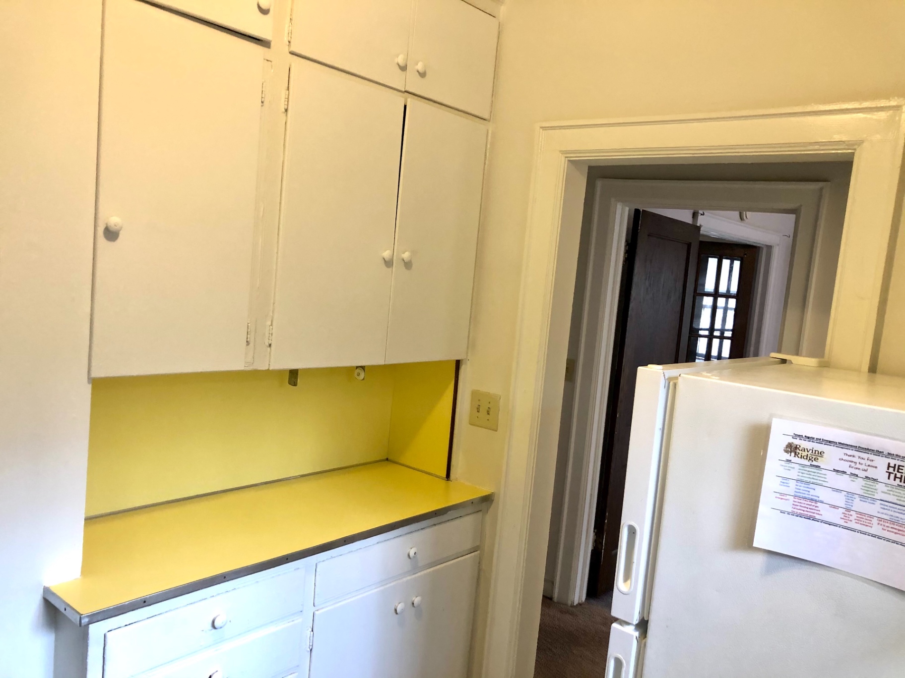 2044 Iuka Ave. B kitchen with ample white cabinet storage and full-size refrigerator