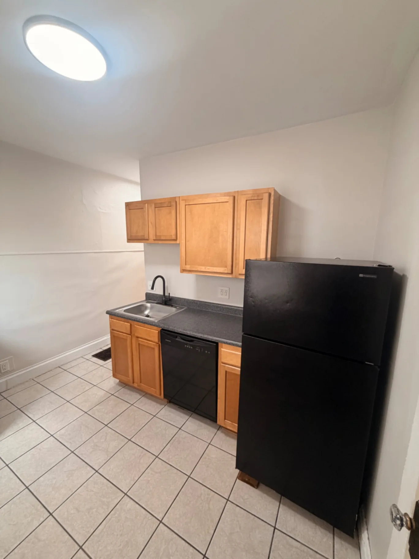 1816 Summit St. kitchen with wood cabinets, dishwasher, and full-size refrigerator