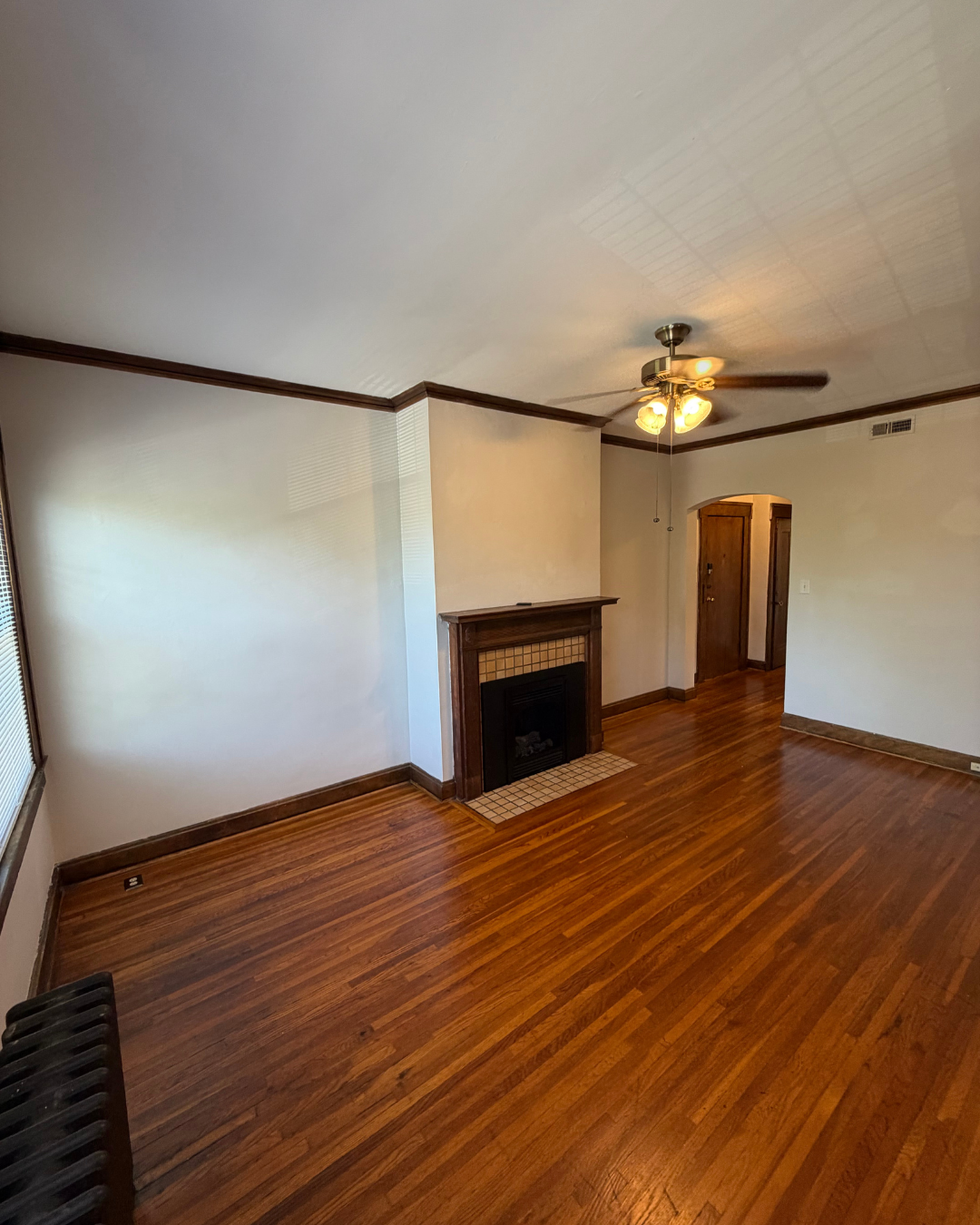 Spacious living room with tiled fireplace and natural light