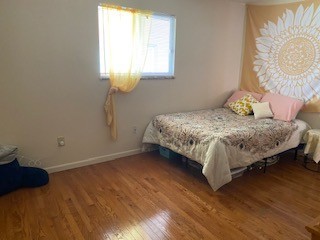 1827 N 4th St. Unit 7 carpeted bedroom with bright window and cozy furnishings
