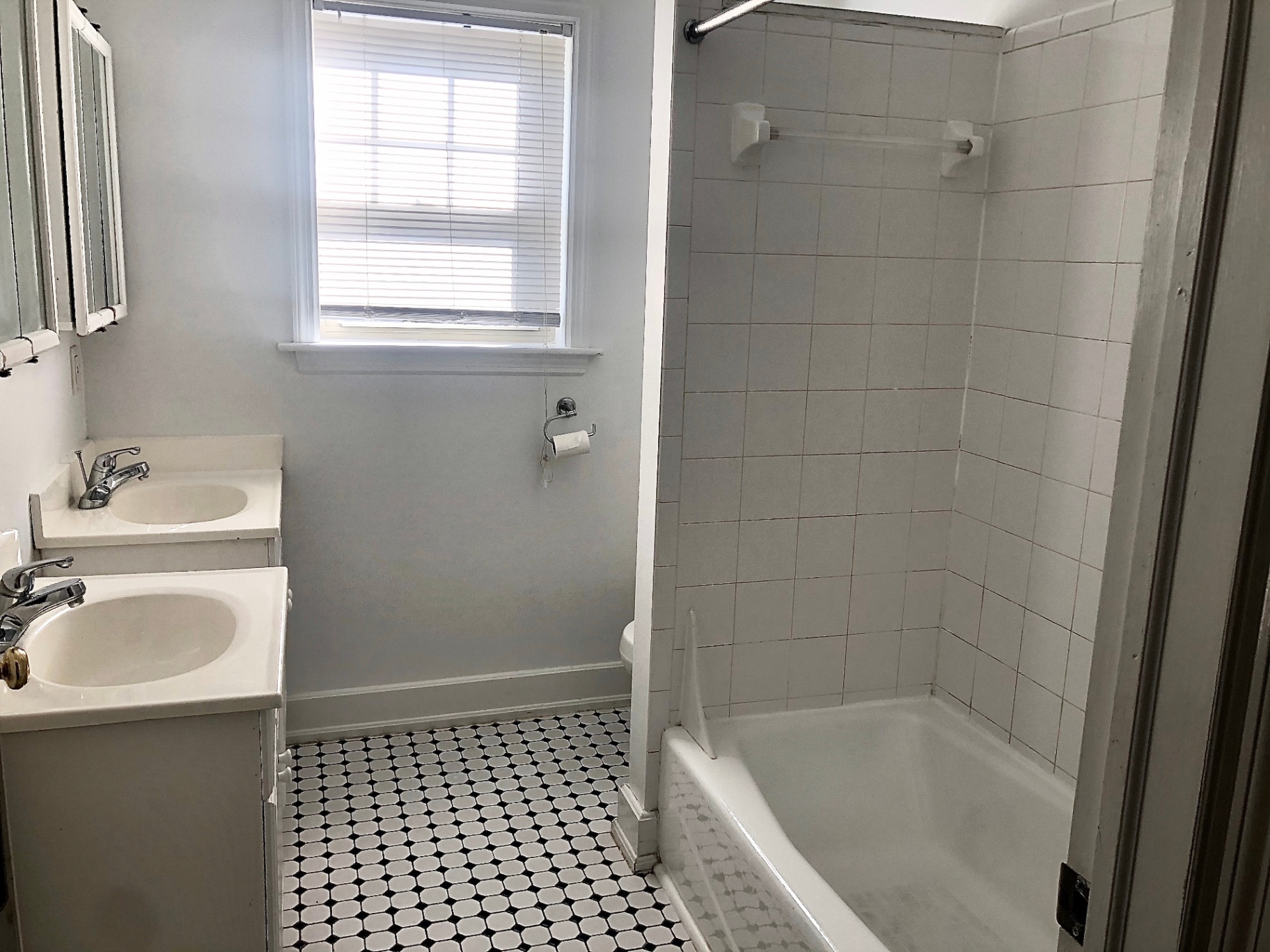 2034 Iuka Ave A double-vanity bathroom with tub and tiled shower
