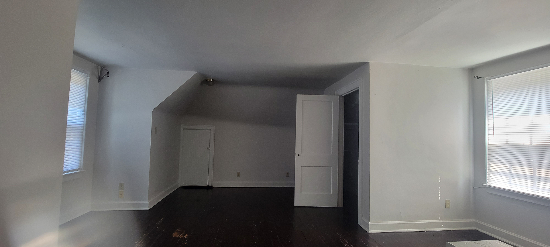 2044 Iuka Ave. C upper-level bonus room with dark-stained floors, dormer ceiling, and closet