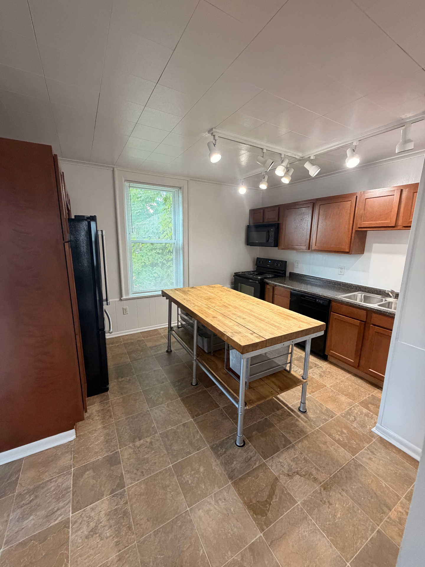 3340 Chestnut Upstairs wide kitchen view with butcher-block island, track lighting and full appliance suite