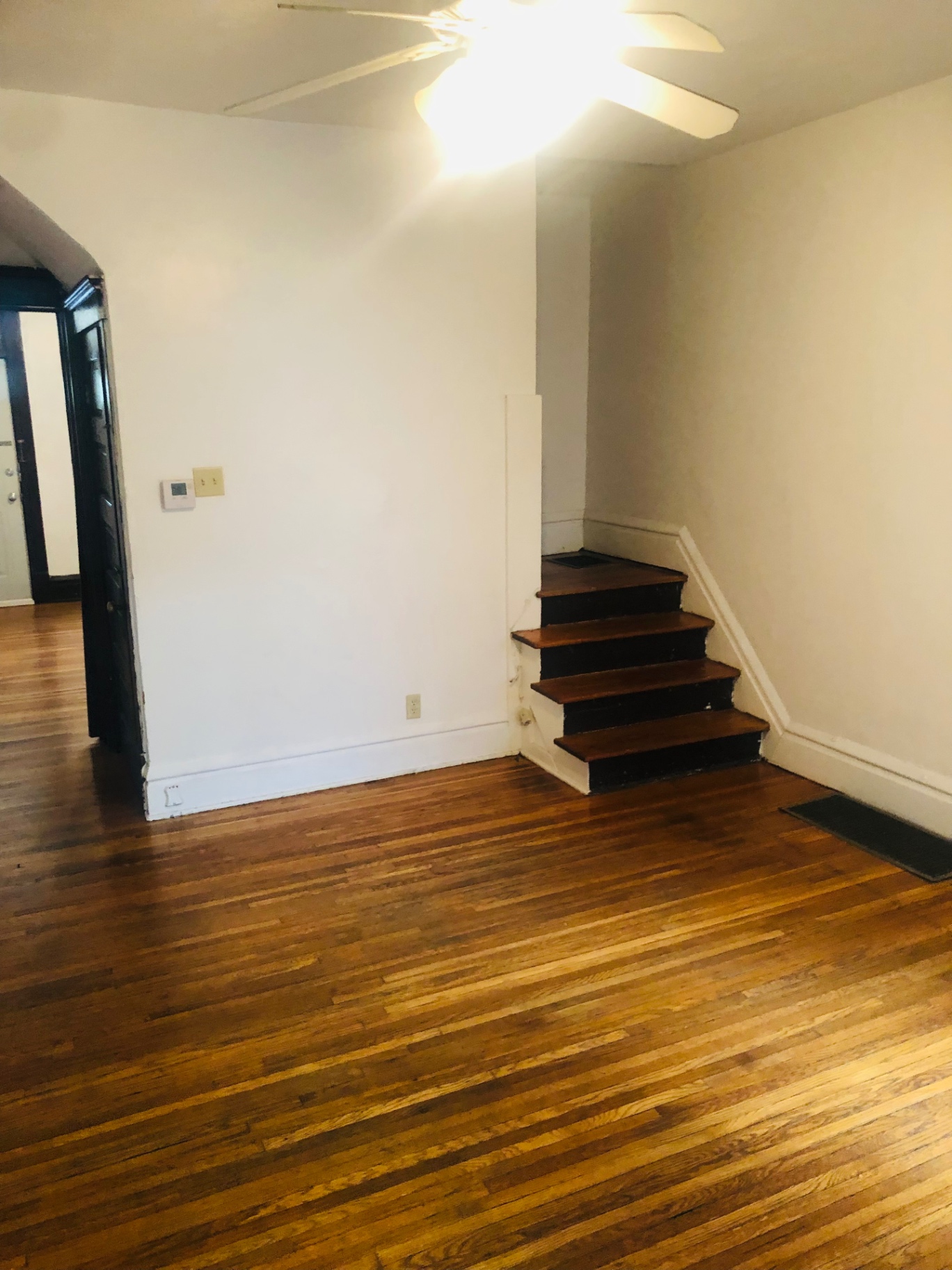 119 W 9th dining/flex room with hardwood floors and staircase