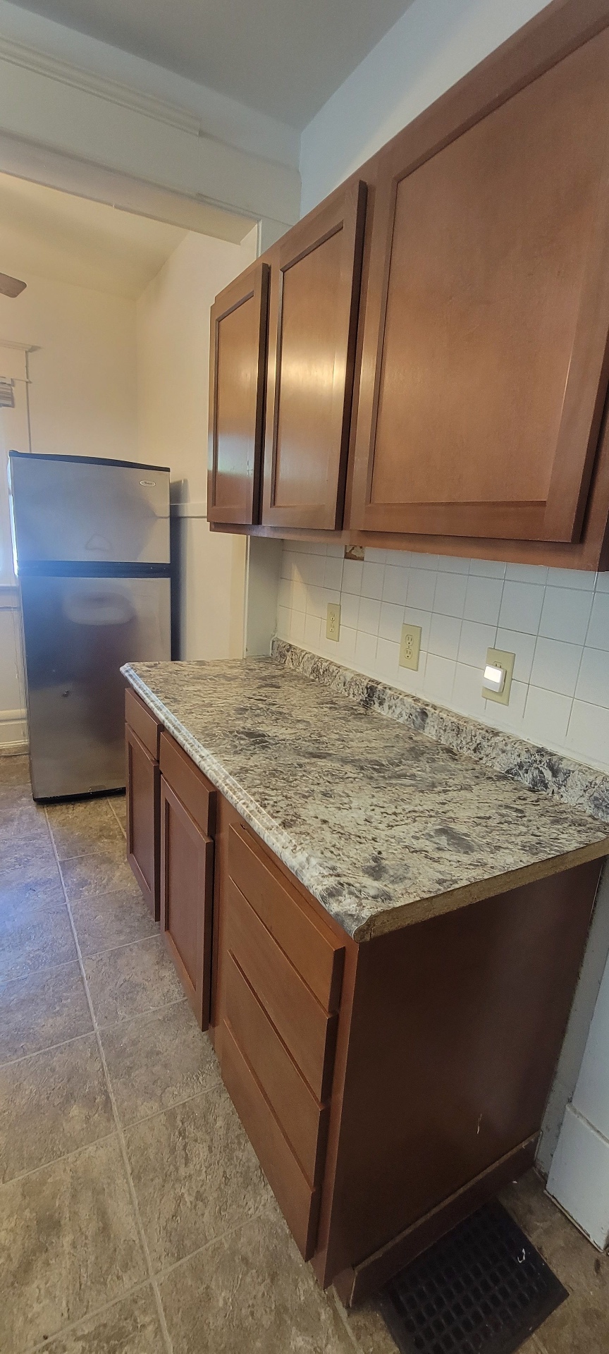 2015 Summit St. kitchen prep counter with maple cabinets and stainless refrigerator
