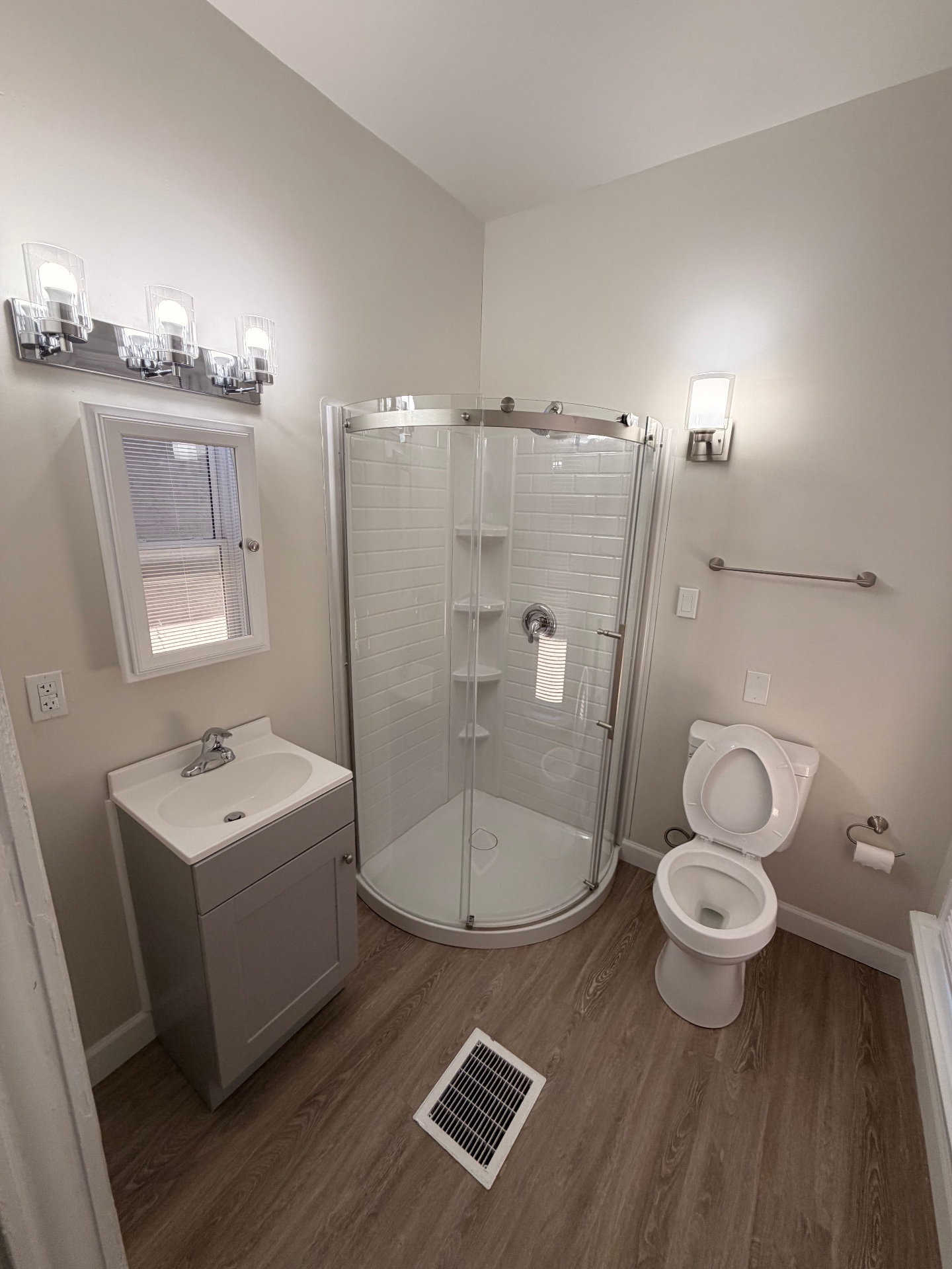 133½ updated bathroom with rounded glass shower, new vanity and chrome fixtures