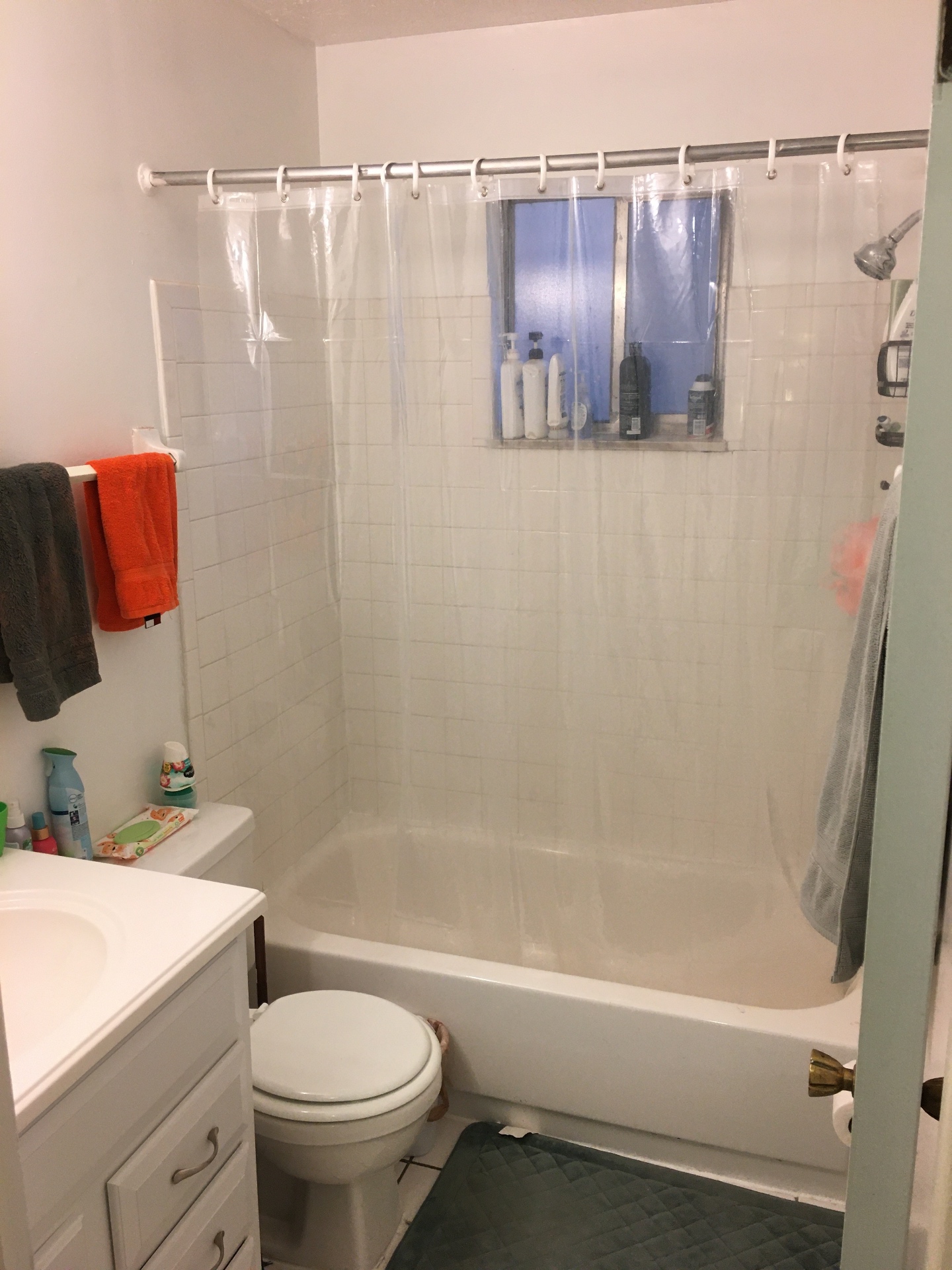 2150 N 4th St. Unit F bathroom with tub and shower curtain, vanity, and window