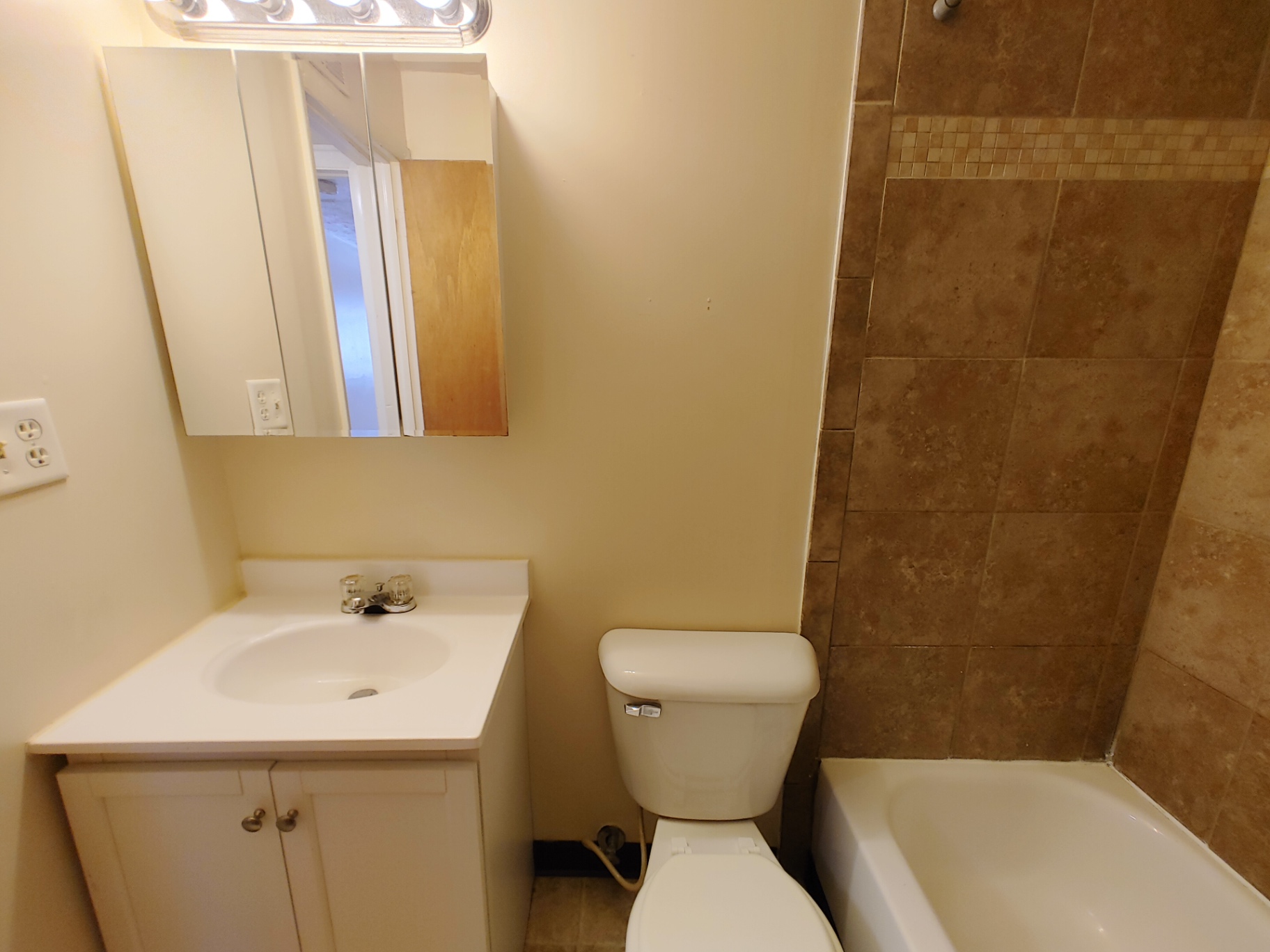 2150 N 4th St. Unit B bathroom with pedestal vanity, medicine cabinet, and tiled shower