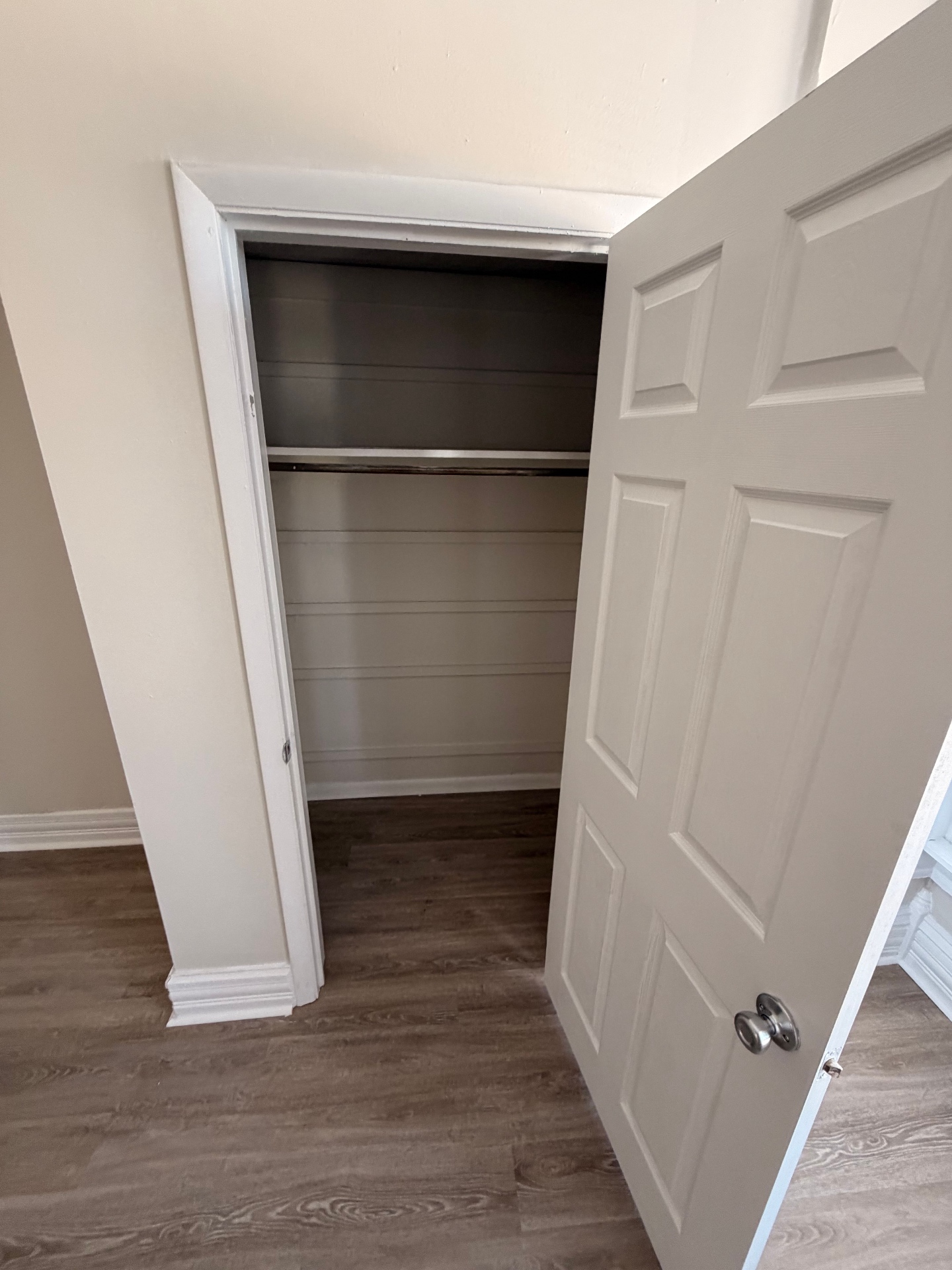 133½ bedroom closet with hanging rod and upper shelf storage