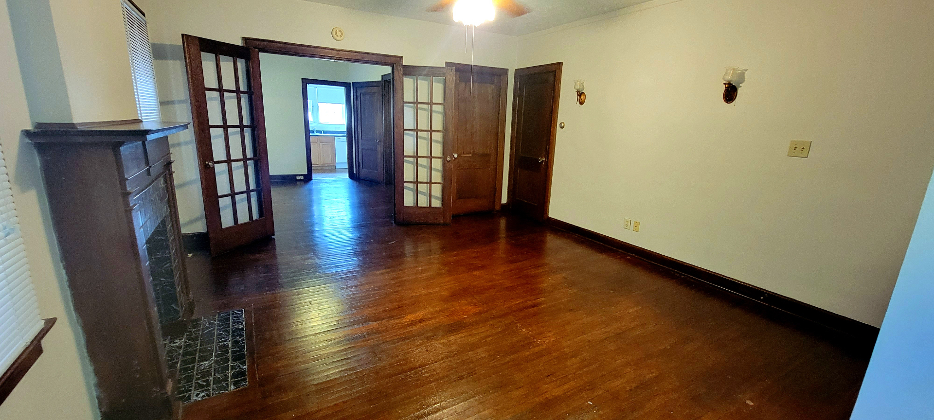 2048 Iuka Ave. A living room with French doors, dark wood trim, and hardwood floors