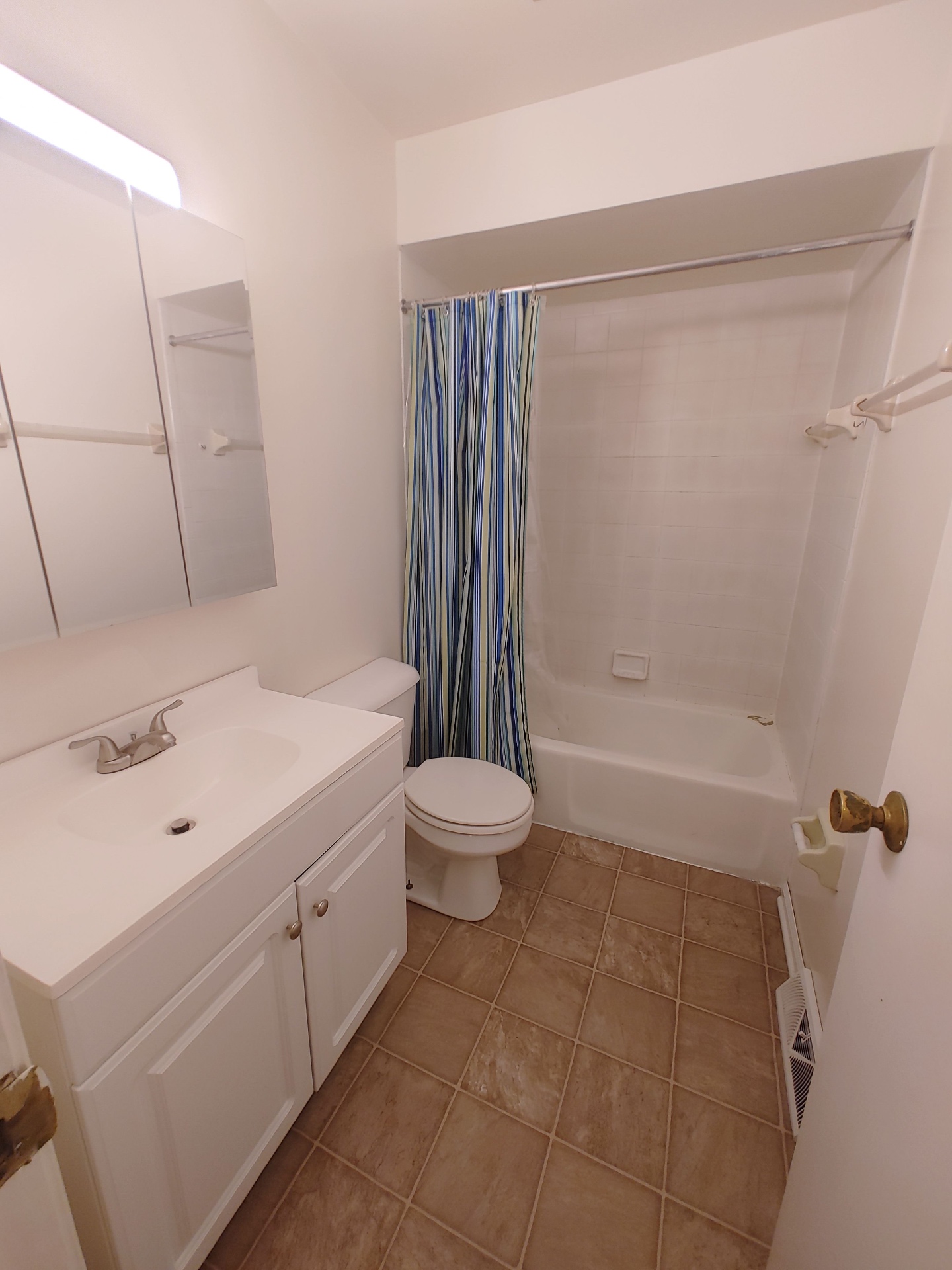 2016 Iuka Ave. bathroom with updated vanity, tub shower, and tile flooring