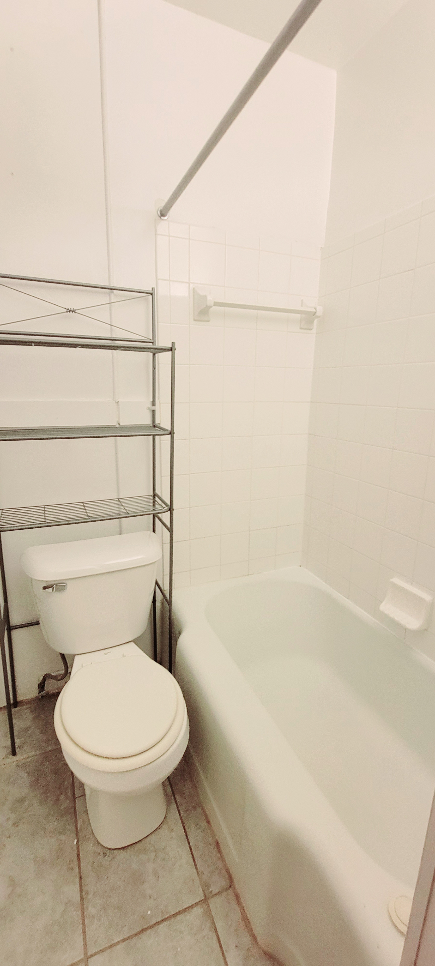 2054 Iuka Ave. C full bathroom with tub, toilet, and tile floor
