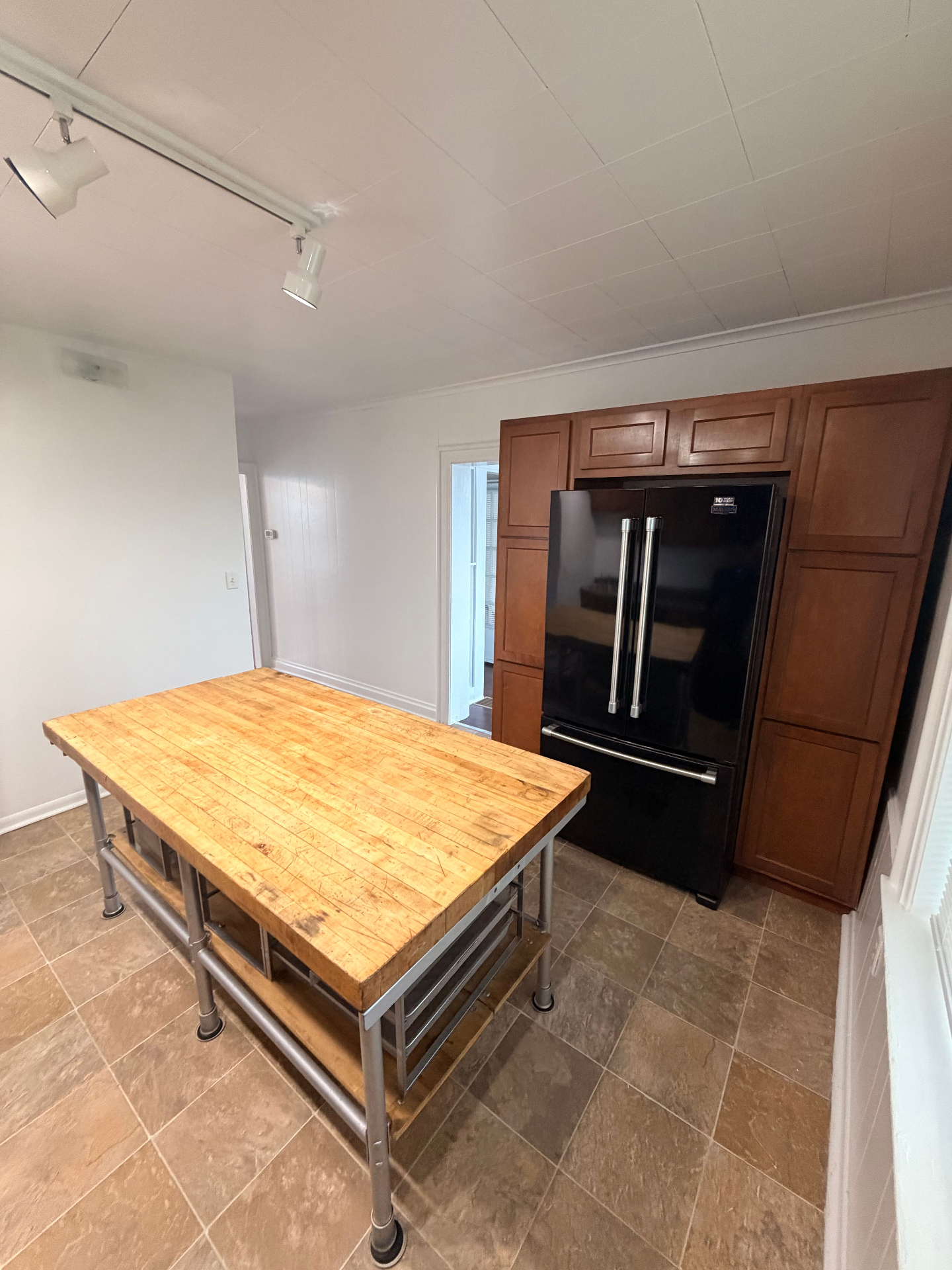 3340 Chestnut Upstairs kitchen with black French-door fridge and full-height pantry cabinetry