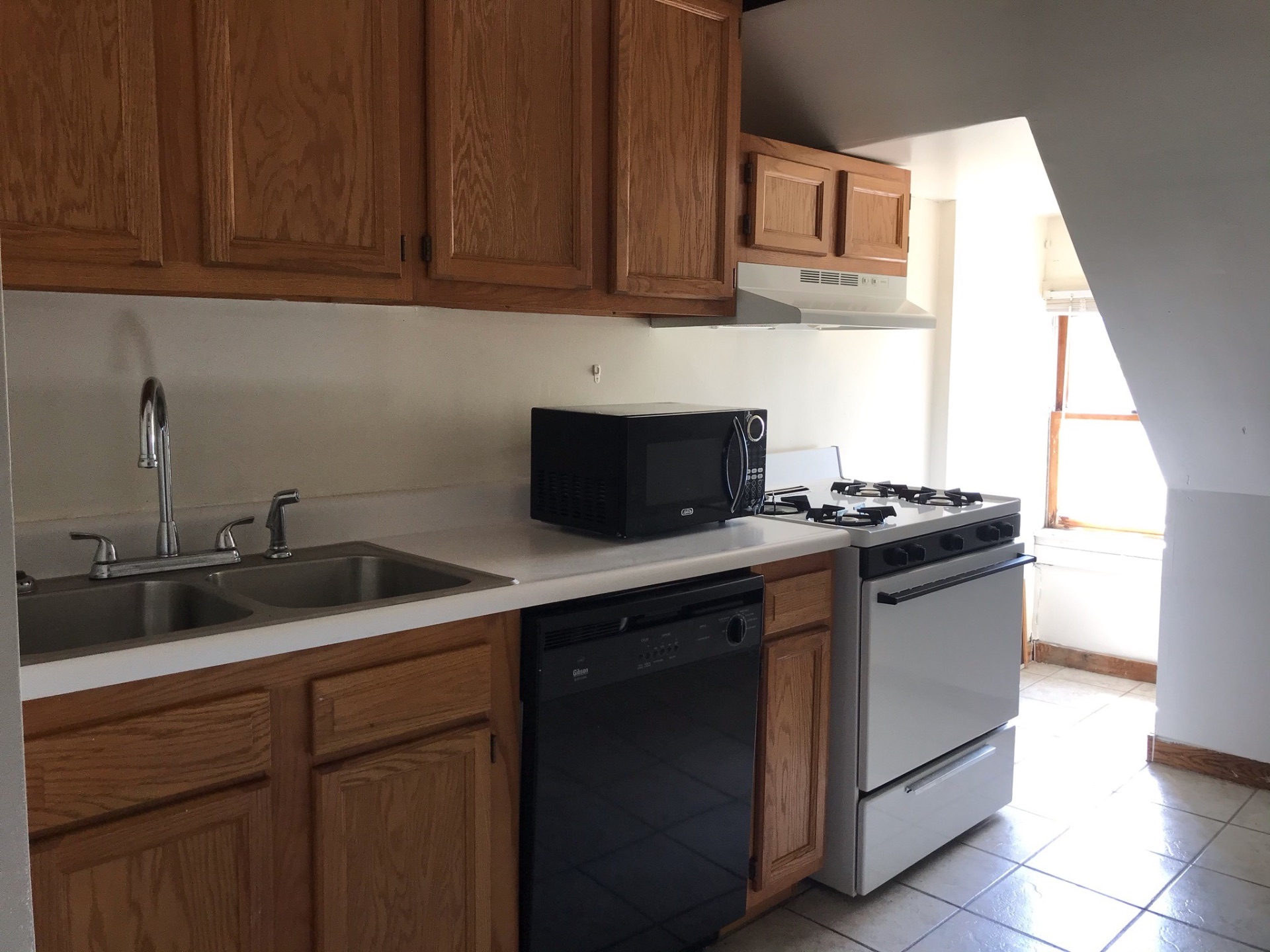 89 E Woodruff Ave. Unit C kitchen with double stainless sink, dishwasher, and dedicated stove nook