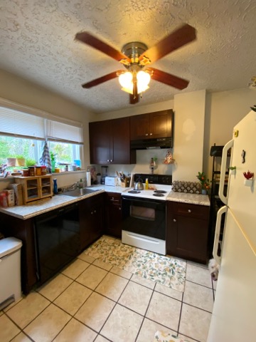 2155 N 4th St. kitchen with dark cabinetry, electric range, and tile floor