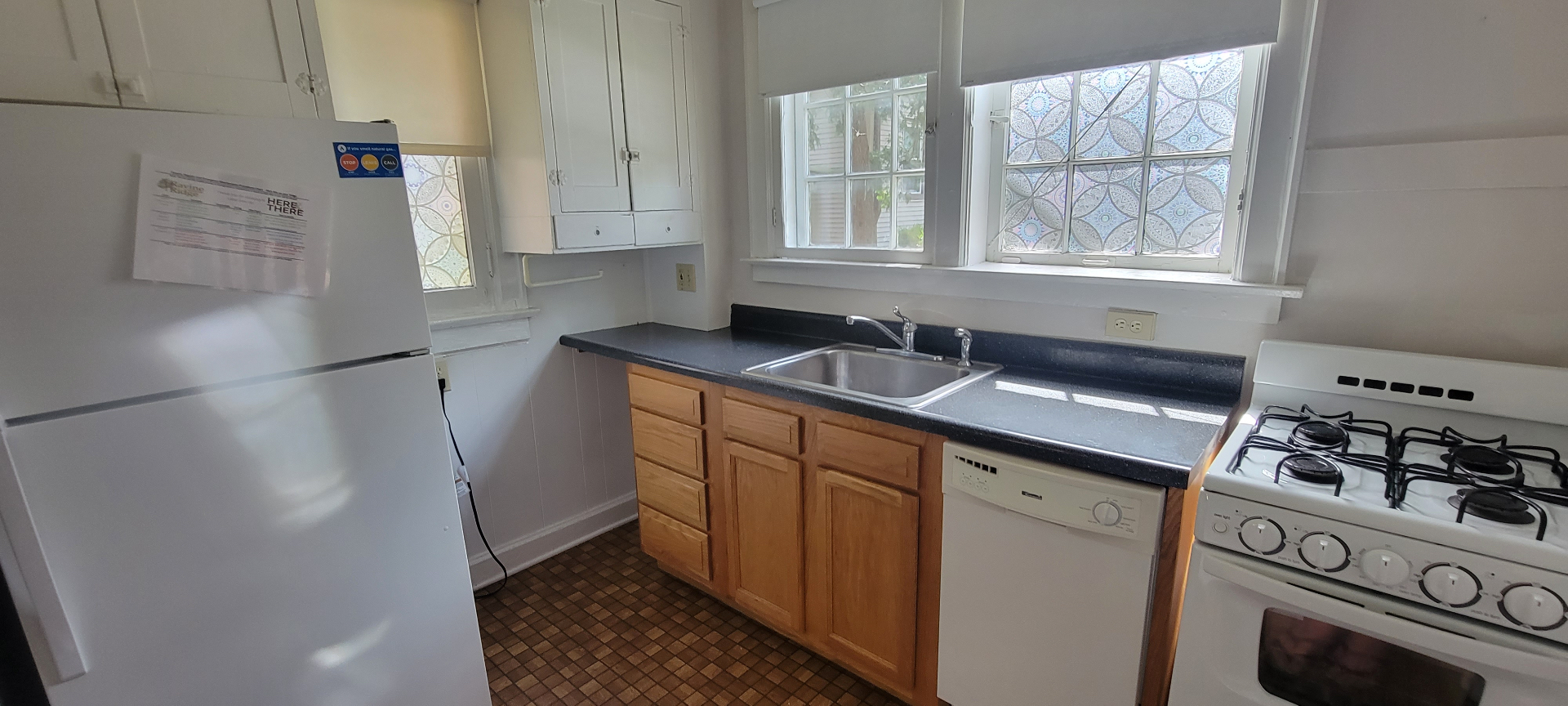 2048 Iuka Ave. A kitchen with double sink, gas range, and large corner windows