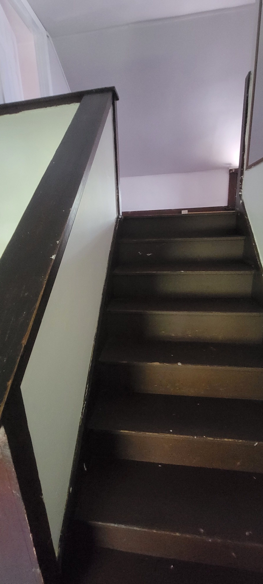 2015 Summit St. dark-stained wood staircase leading to the third floor