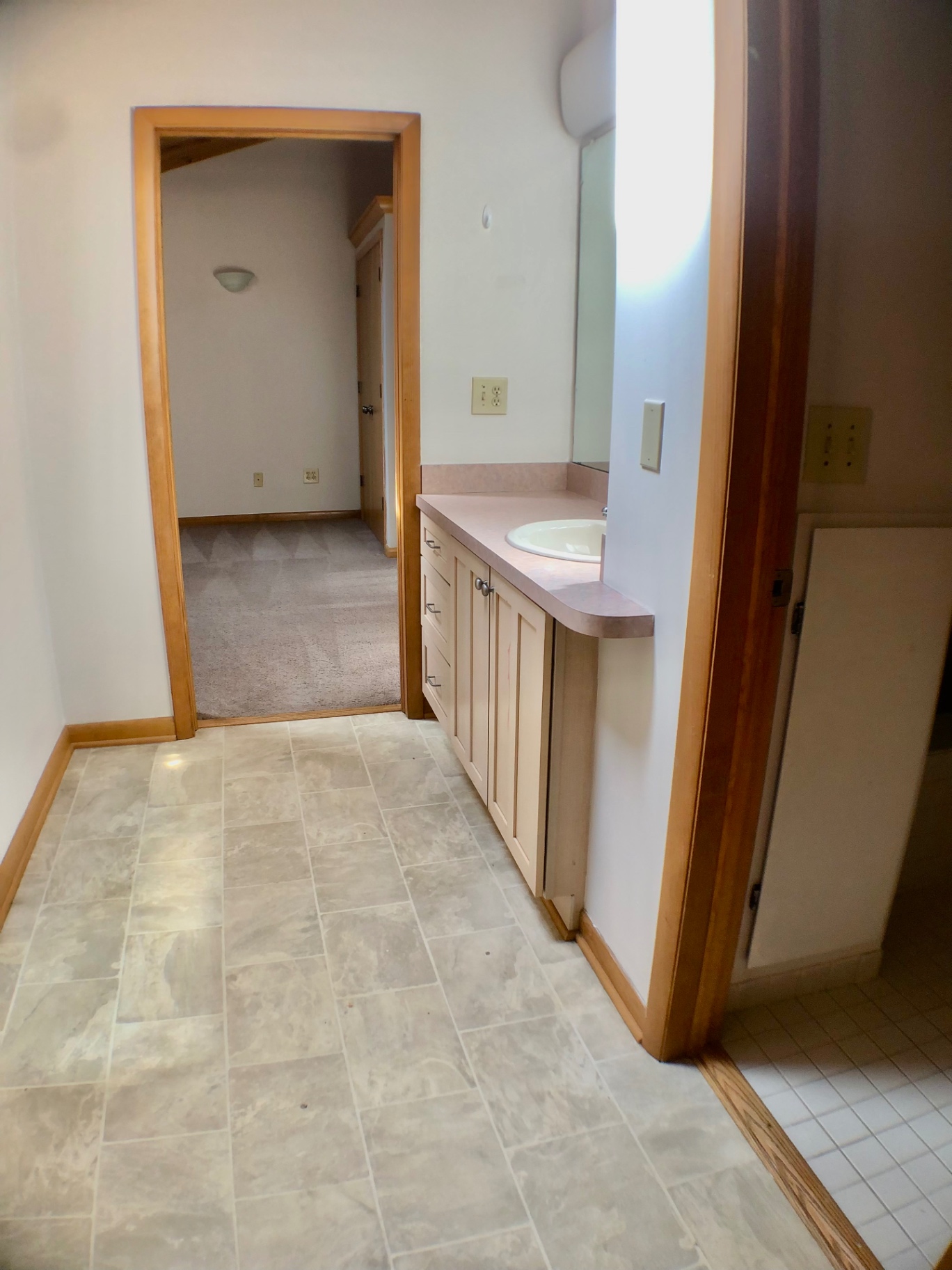2040 Iuka Ave House bathroom hallway with vanity, mirror, and tile flooring