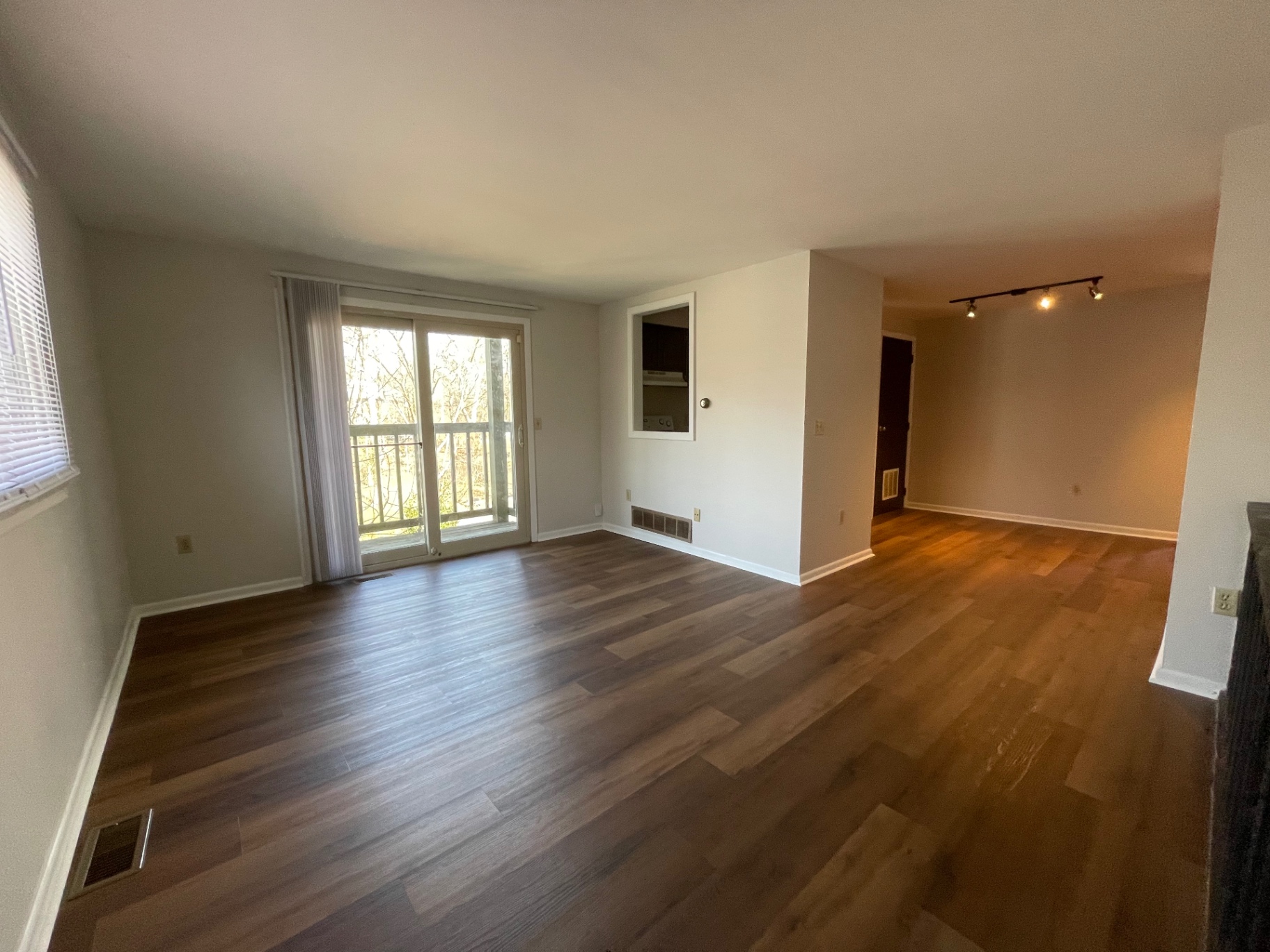 2020 Summit St. bright open living room with sliding doors to a private balcony overlooking the Iuka Ravine and updated plank floors