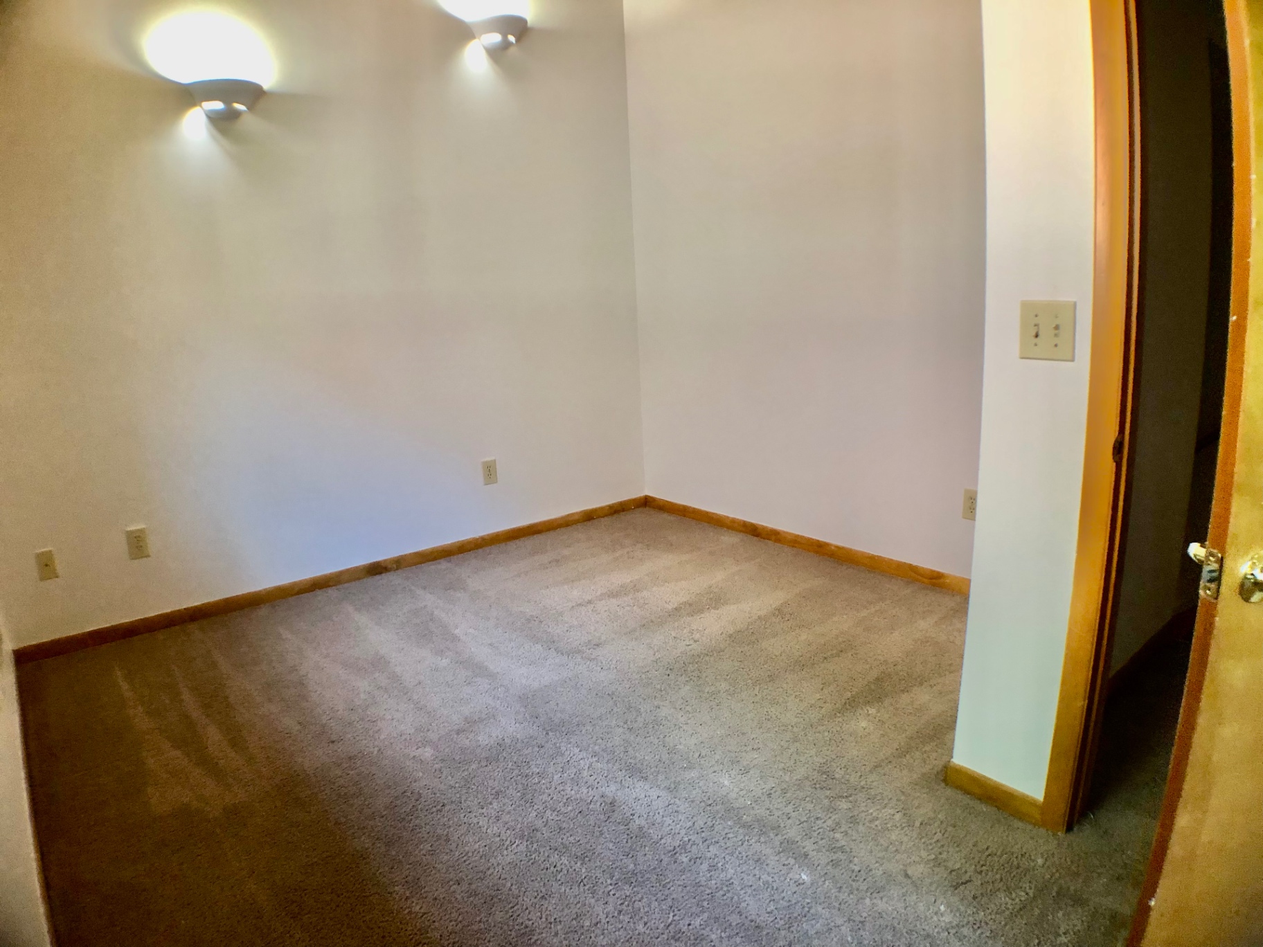 2040 Iuka Ave House bedroom with wall sconces and archway entry