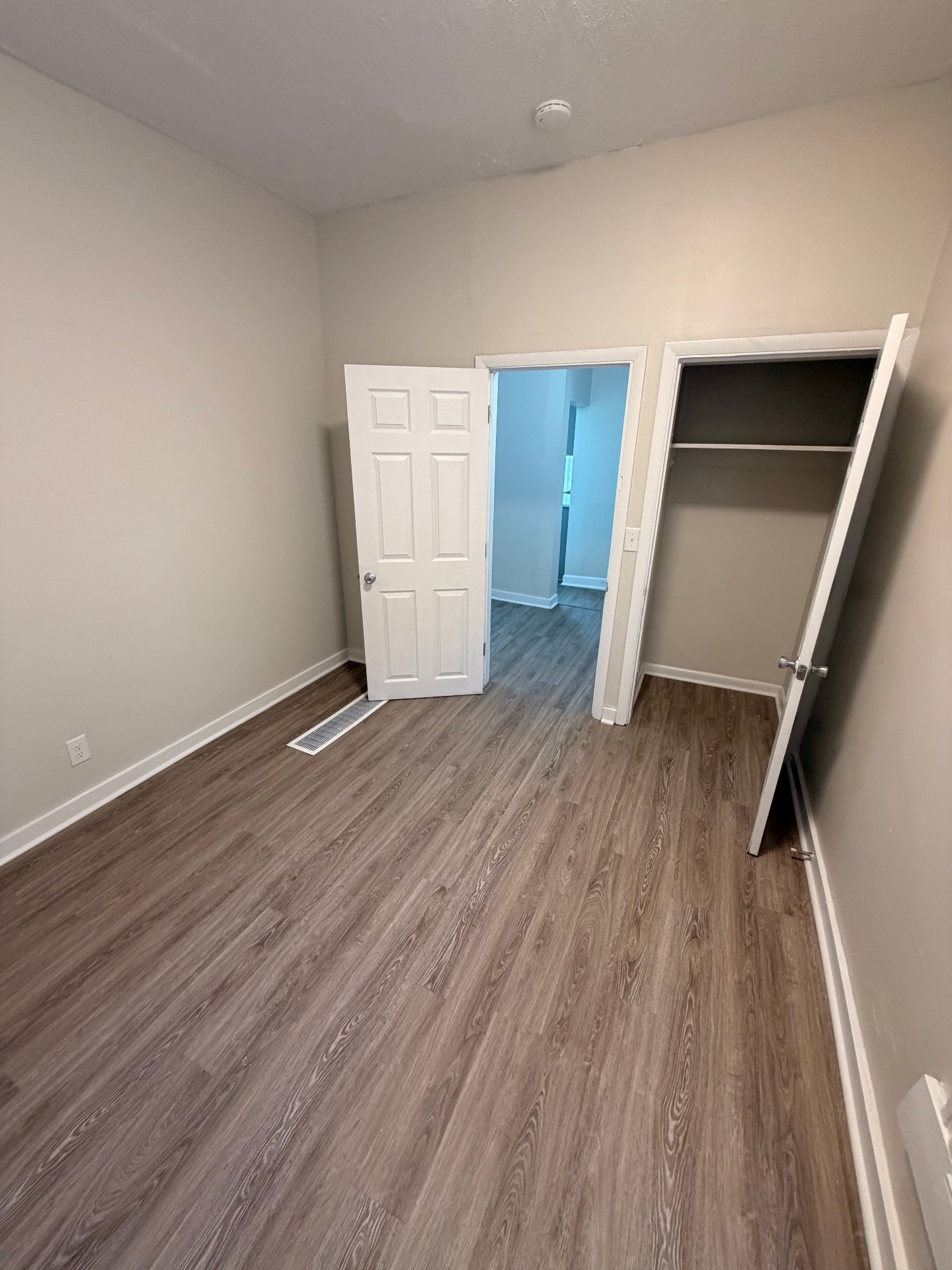133½ bedroom with built-in closet and plank flooring