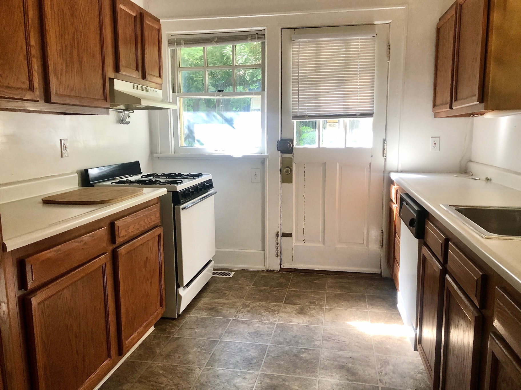 2034 Iuka Ave A kitchen with gas range, dishwasher, and back door to the porch