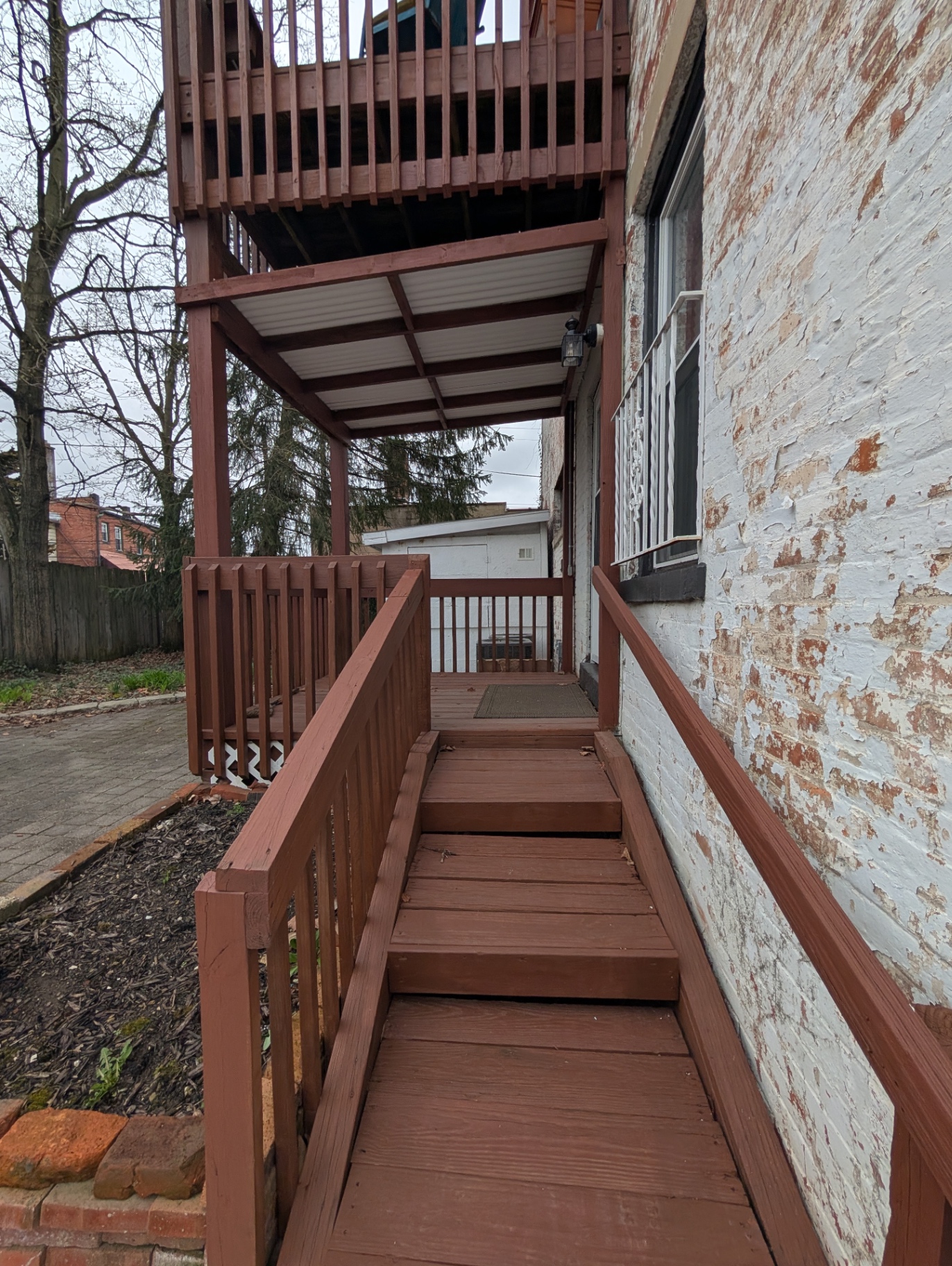 3338 Chestnut covered back entry ramp leading to the downstairs unit door