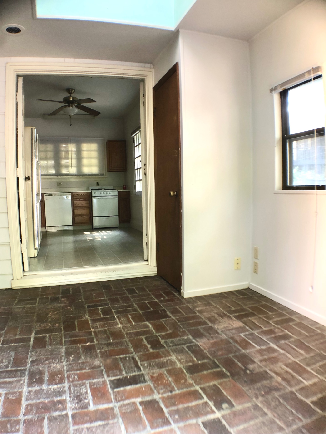 2026 Iuka Ave A dining area with brick floor and open pass-through to kitchen