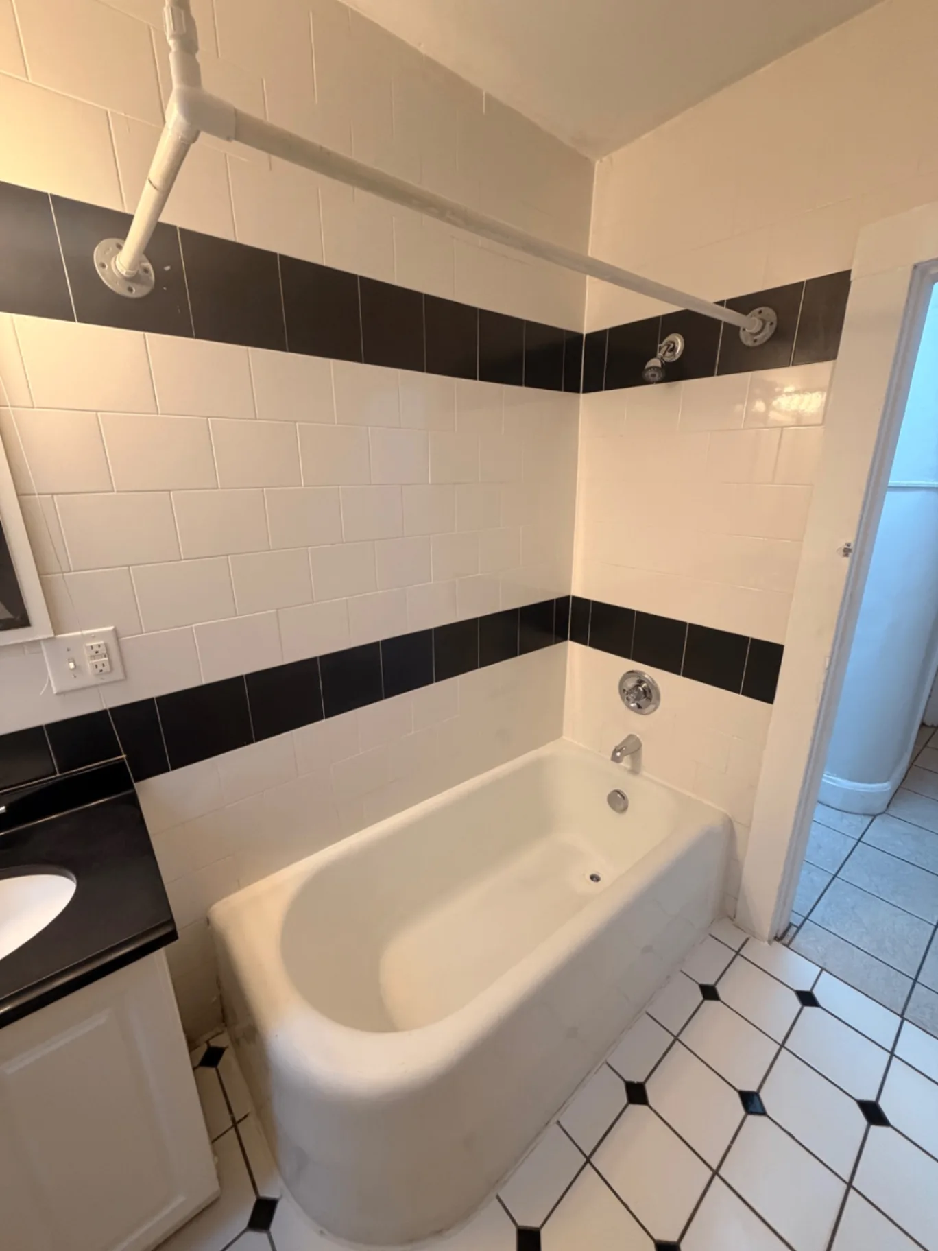 1816 Summit St. bathroom tub and shower with white subway and black accent tile