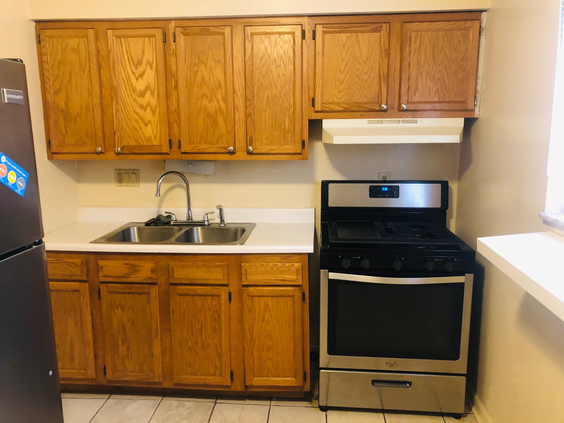 2150 N 4th St. Unit A kitchen with oak cabinets, gas range, and stainless fridge