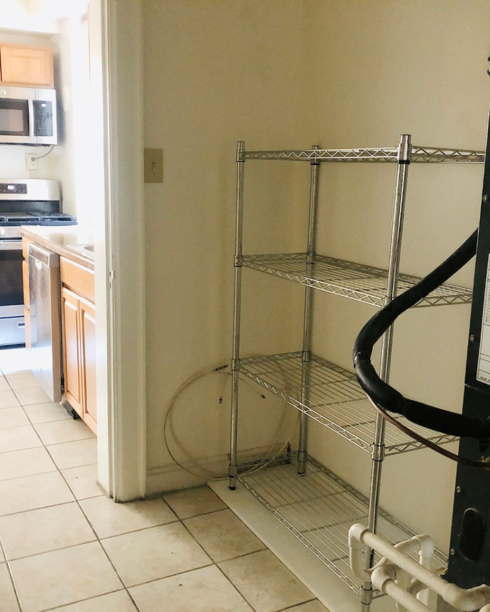 Unit A pantry area with wire shelving off the kitchen