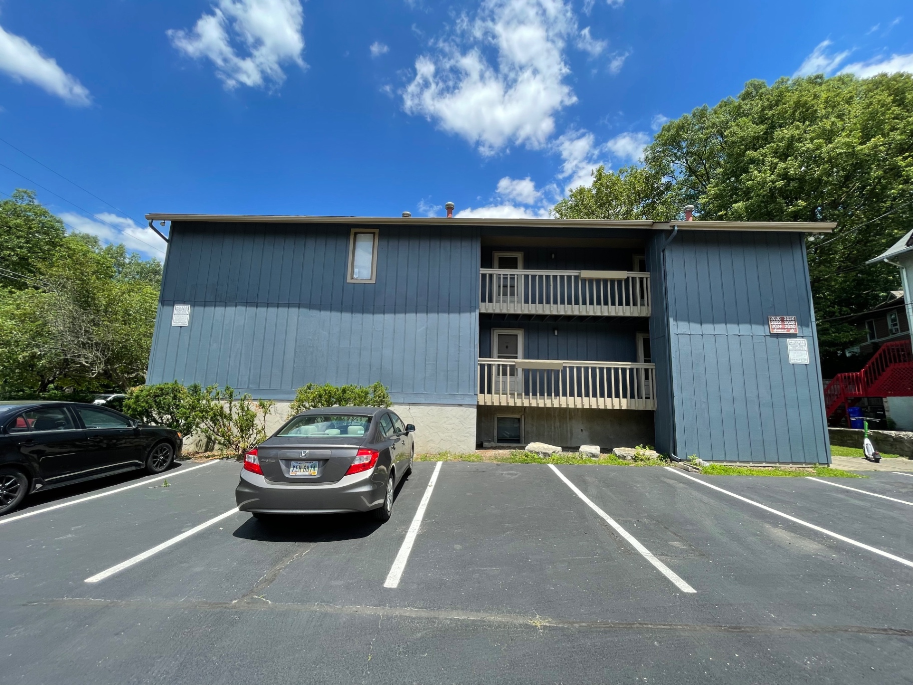 2024 Summit St. exterior — two-story building with private balconies and off-street parking