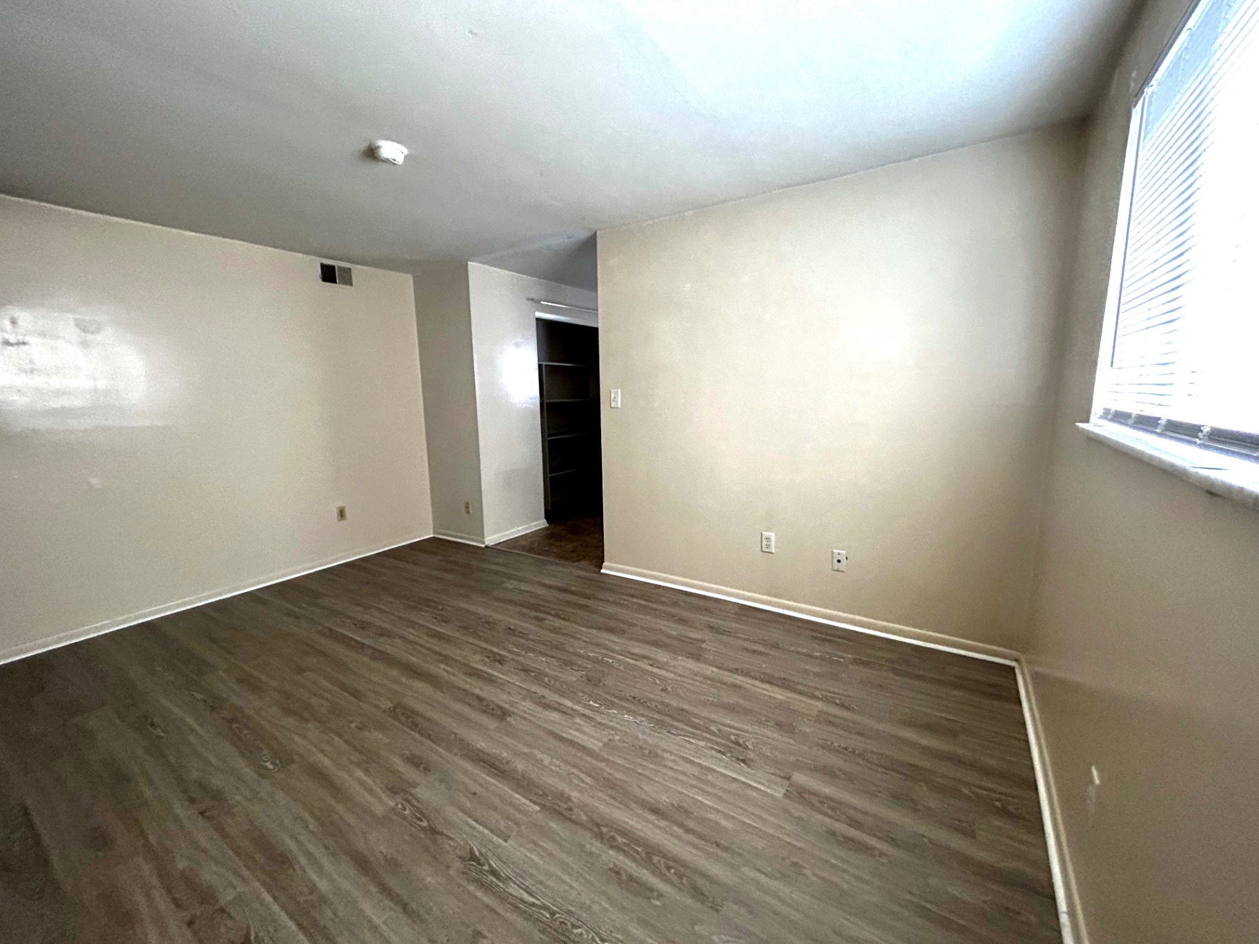 2150 N 4th St. Unit B bedroom with wood-look flooring, bright window, and closet nook