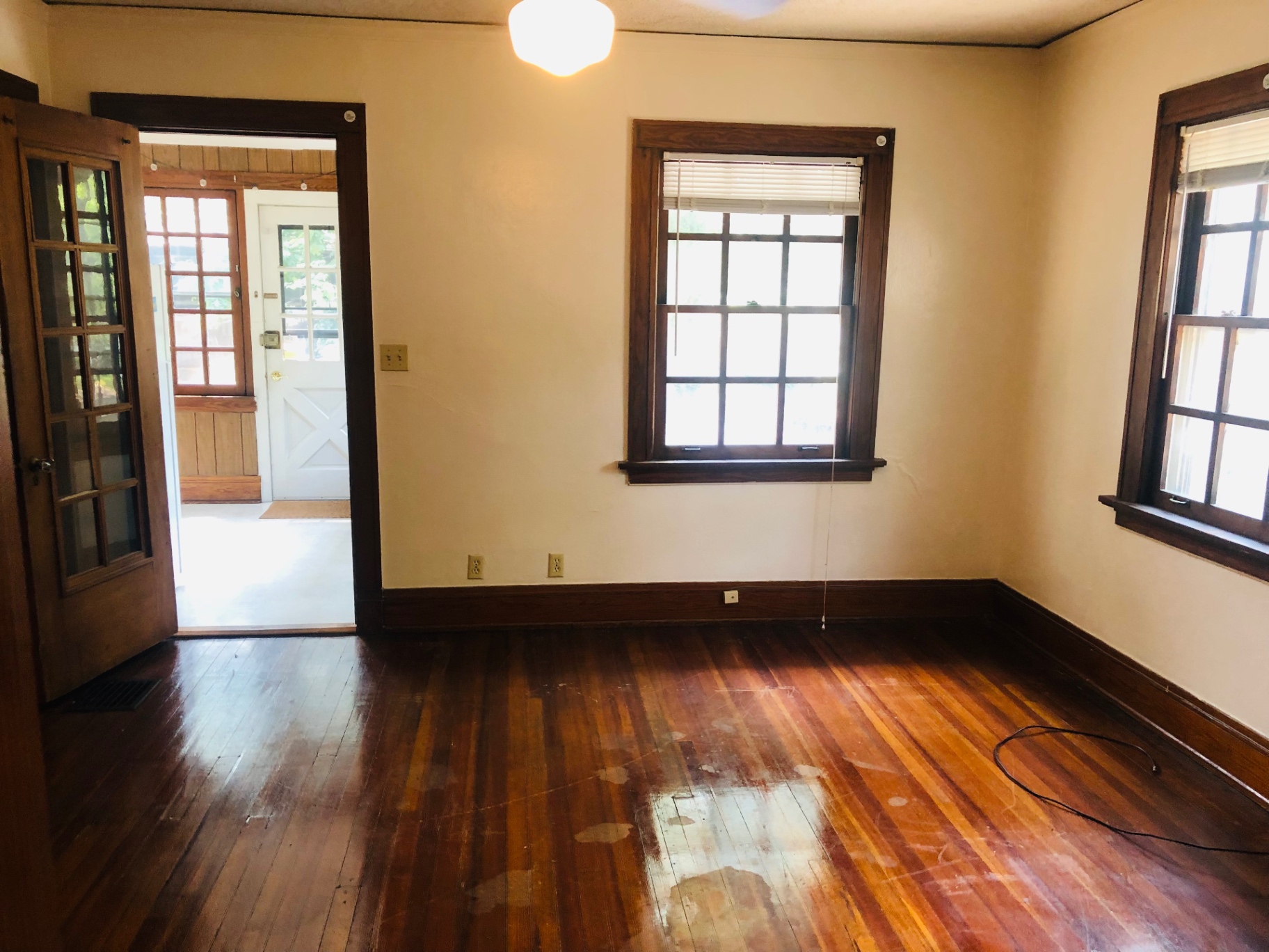 2026 Iuka Ave C room with hardwood floors, French door, and view into sunroom entry