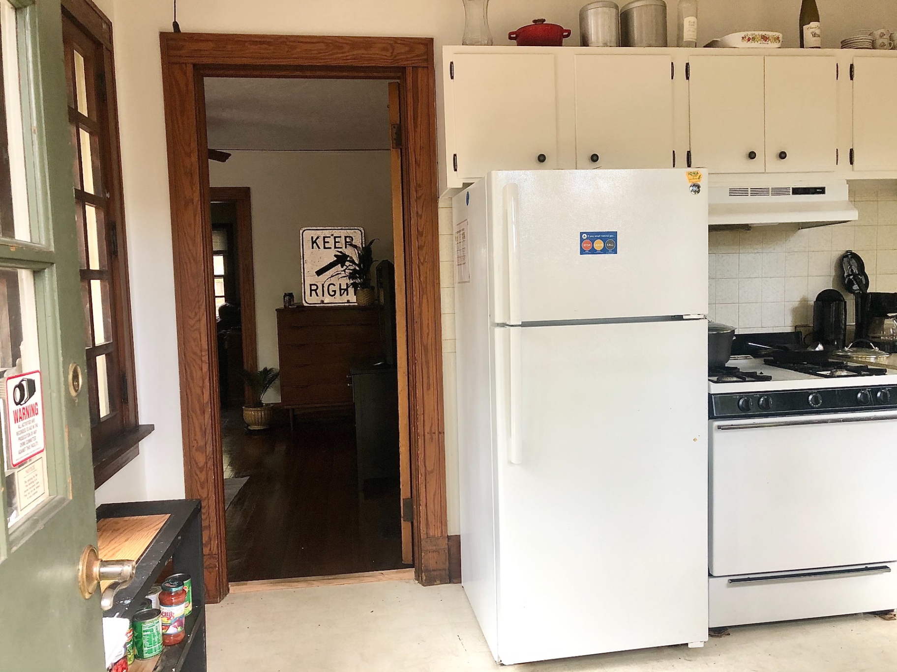 2026 Iuka Ave C kitchen with gas range, refrigerator, and pass-through to dining area