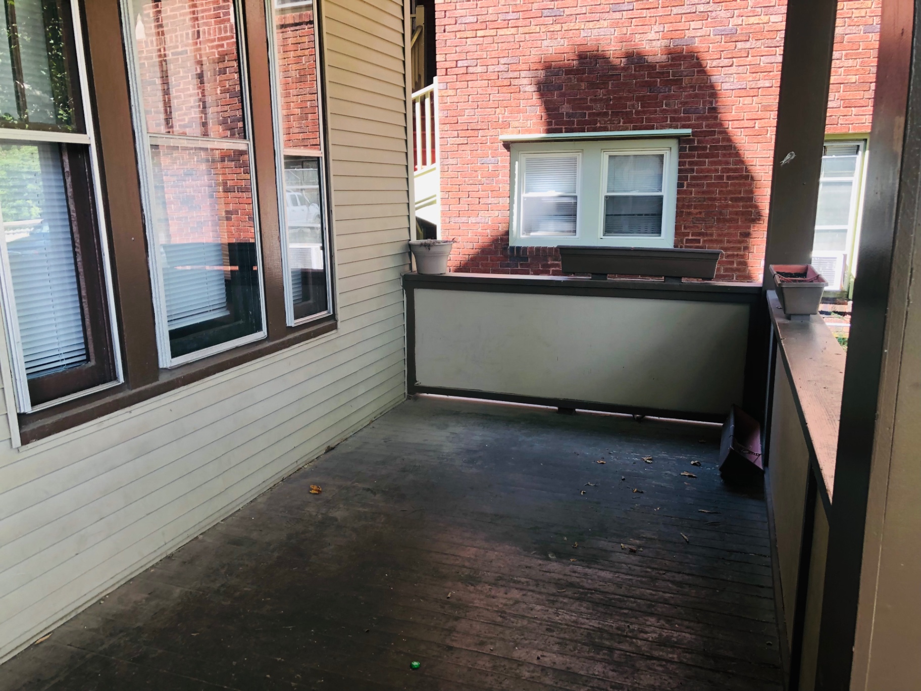 2015 Summit St. covered porch alongside the neighboring brick building